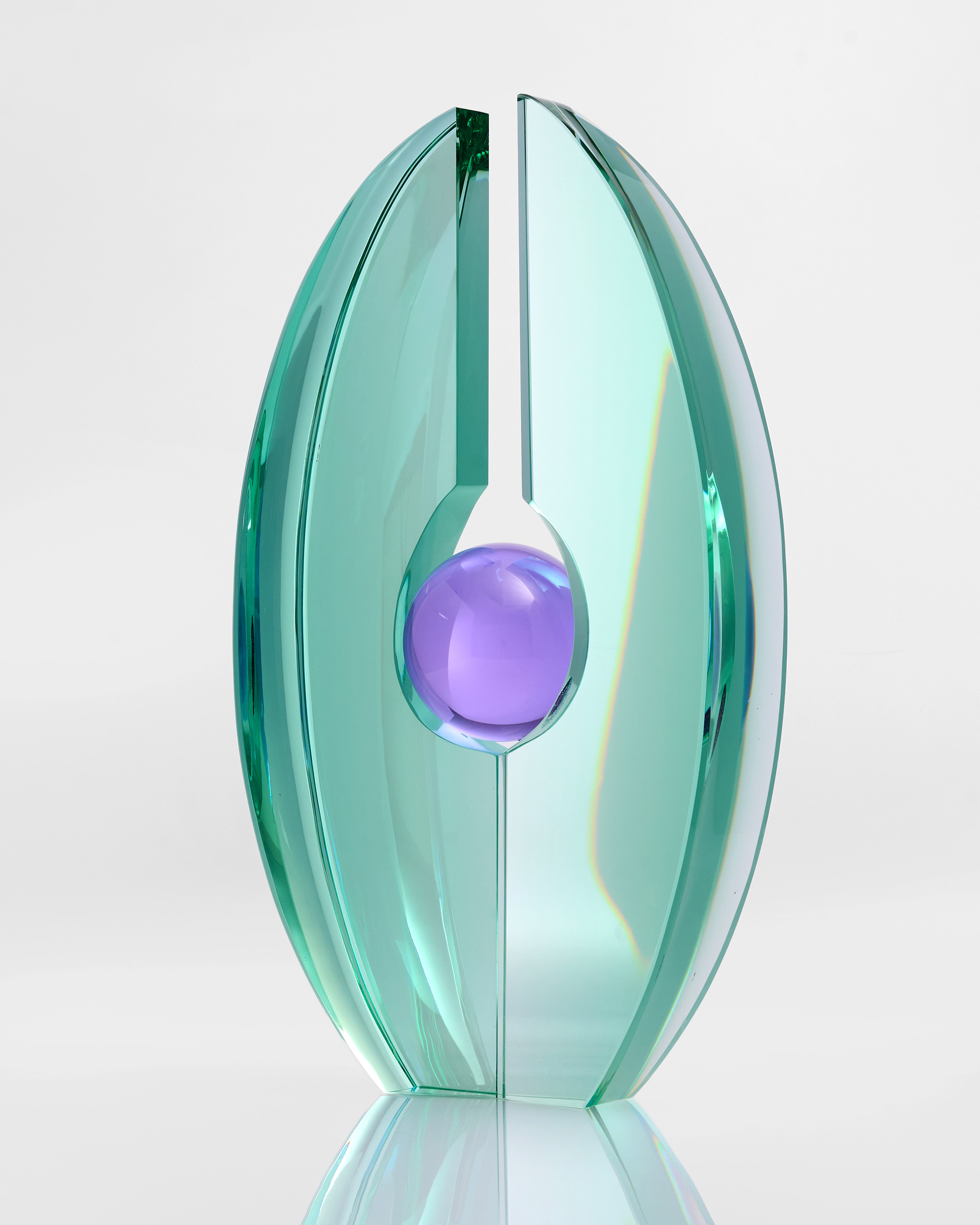 Decorative glass sculpture with a purple sphere in the center on a light gray background