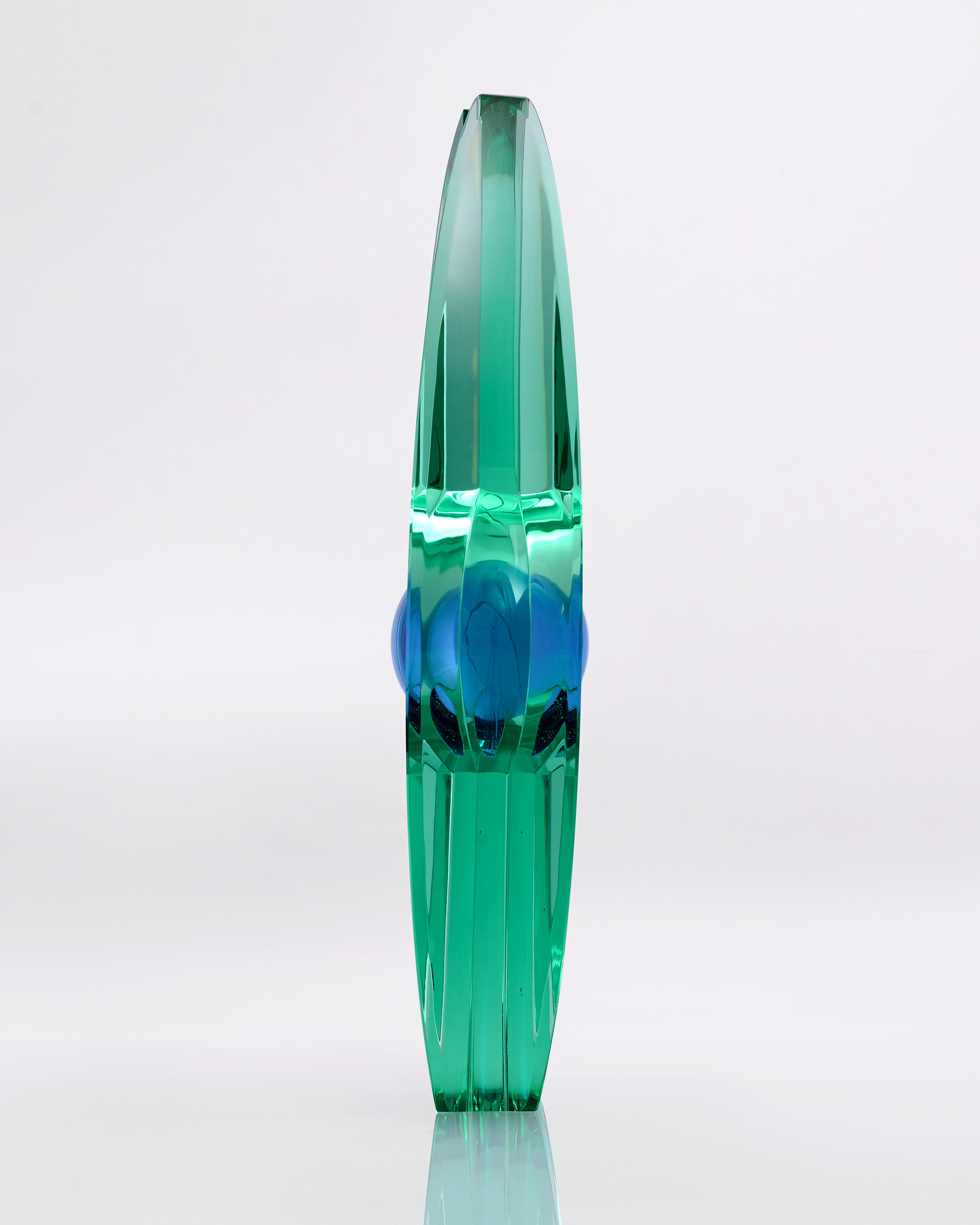 Green and blue glass vase on a white background