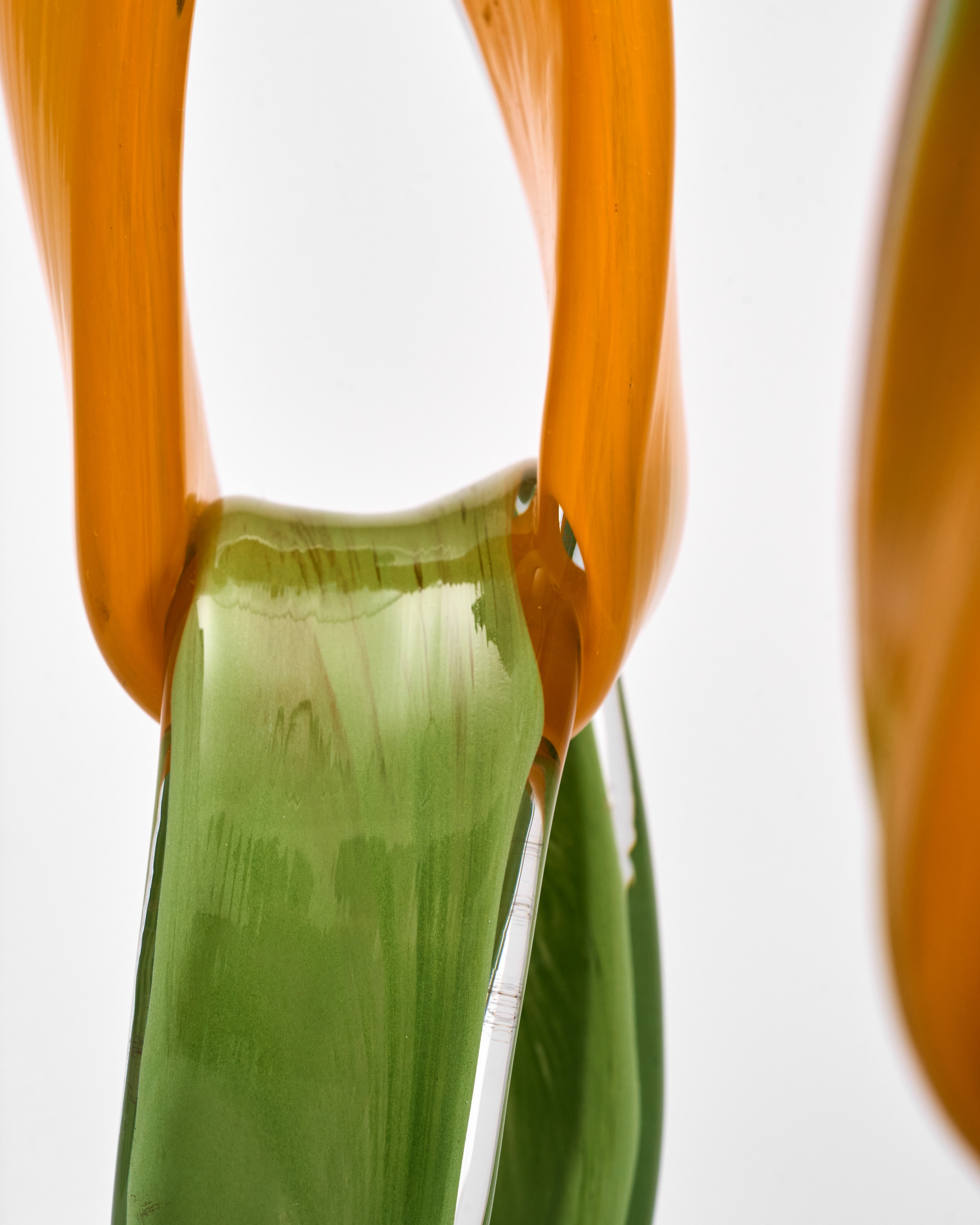 Green and orange candle holder of glass made on a white background