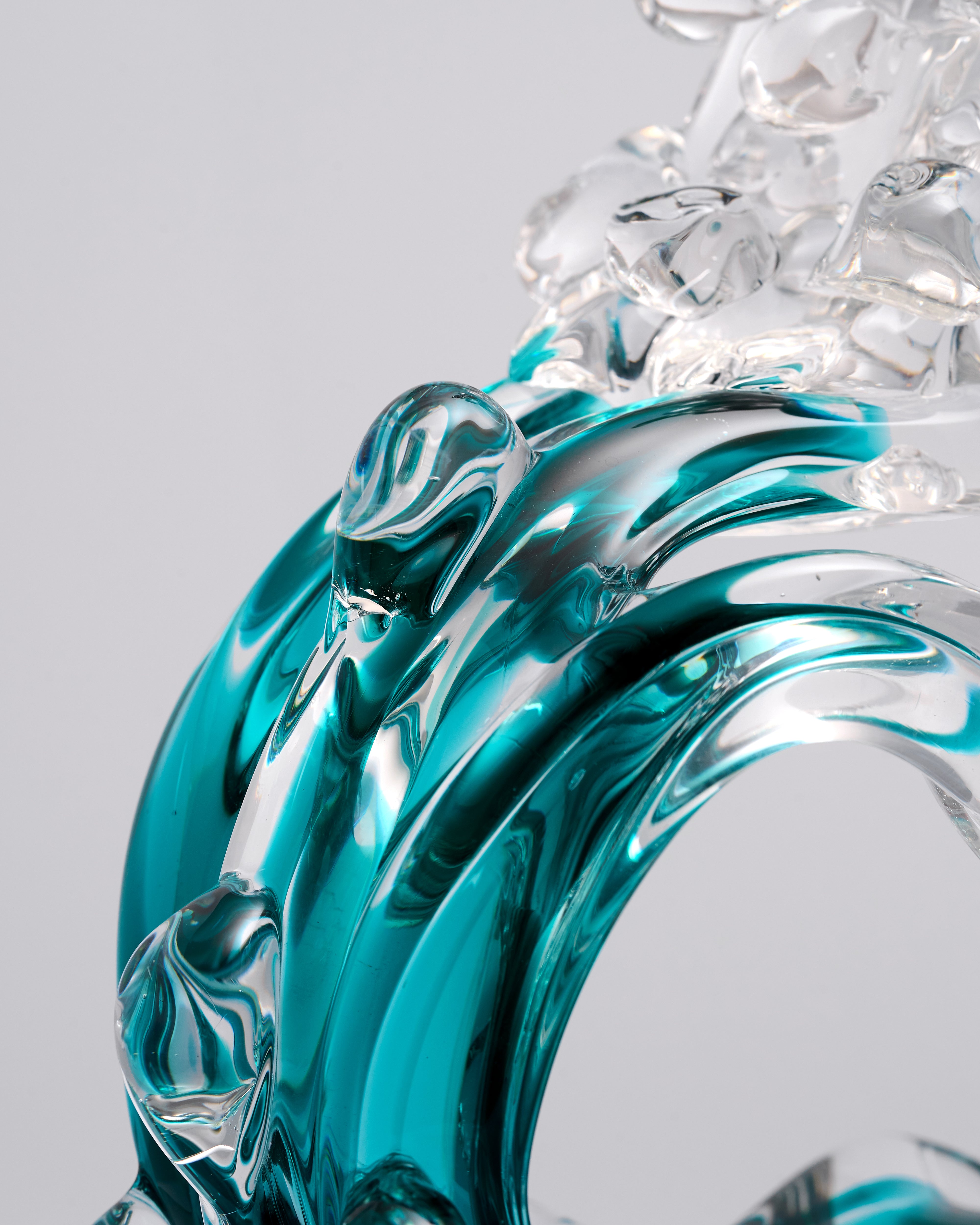 Glass sculpture with blue and clear colors on a gray background Elysian Glow Teal Crystal Decor Set