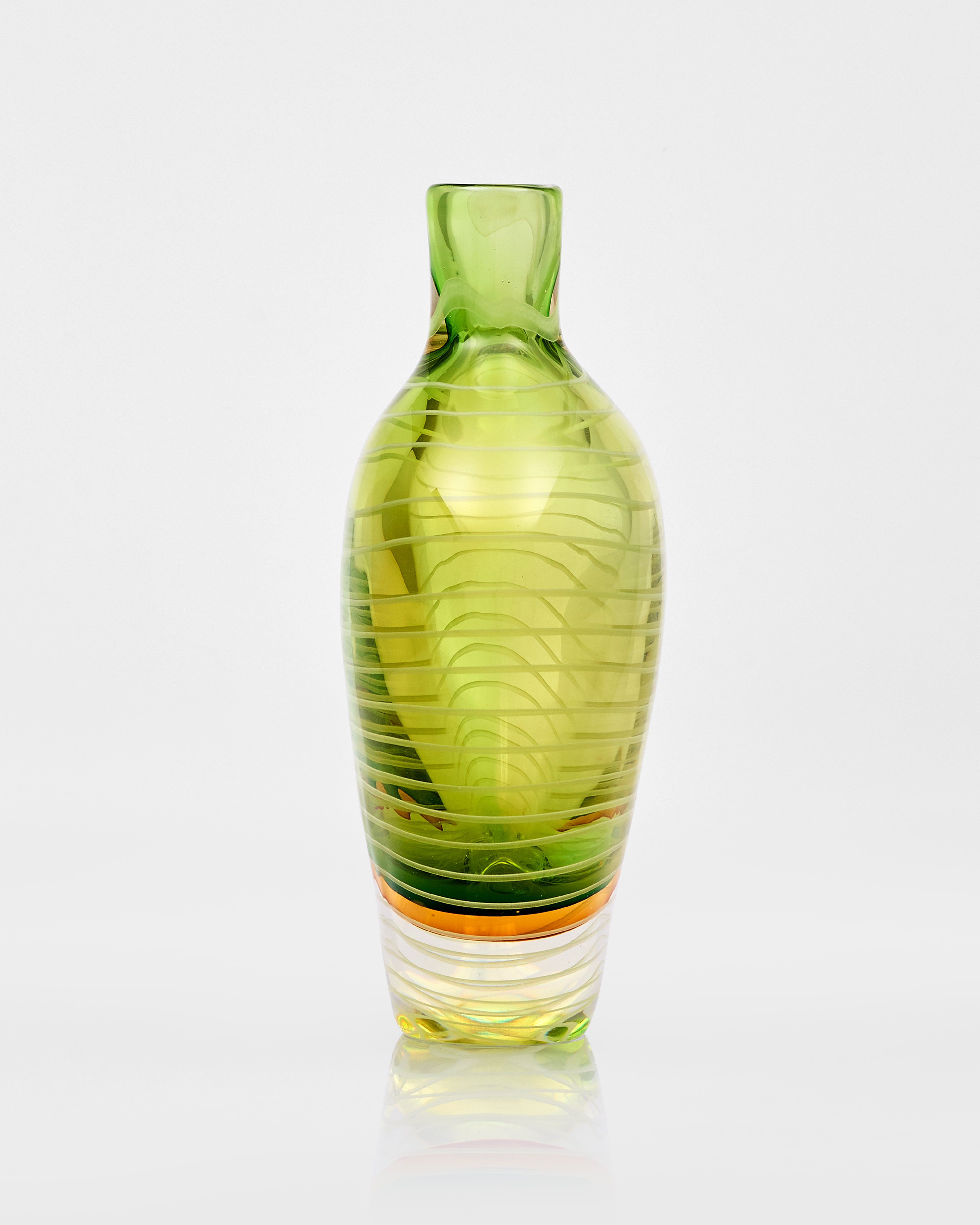 Green glass vase with ribbed texture on a white background