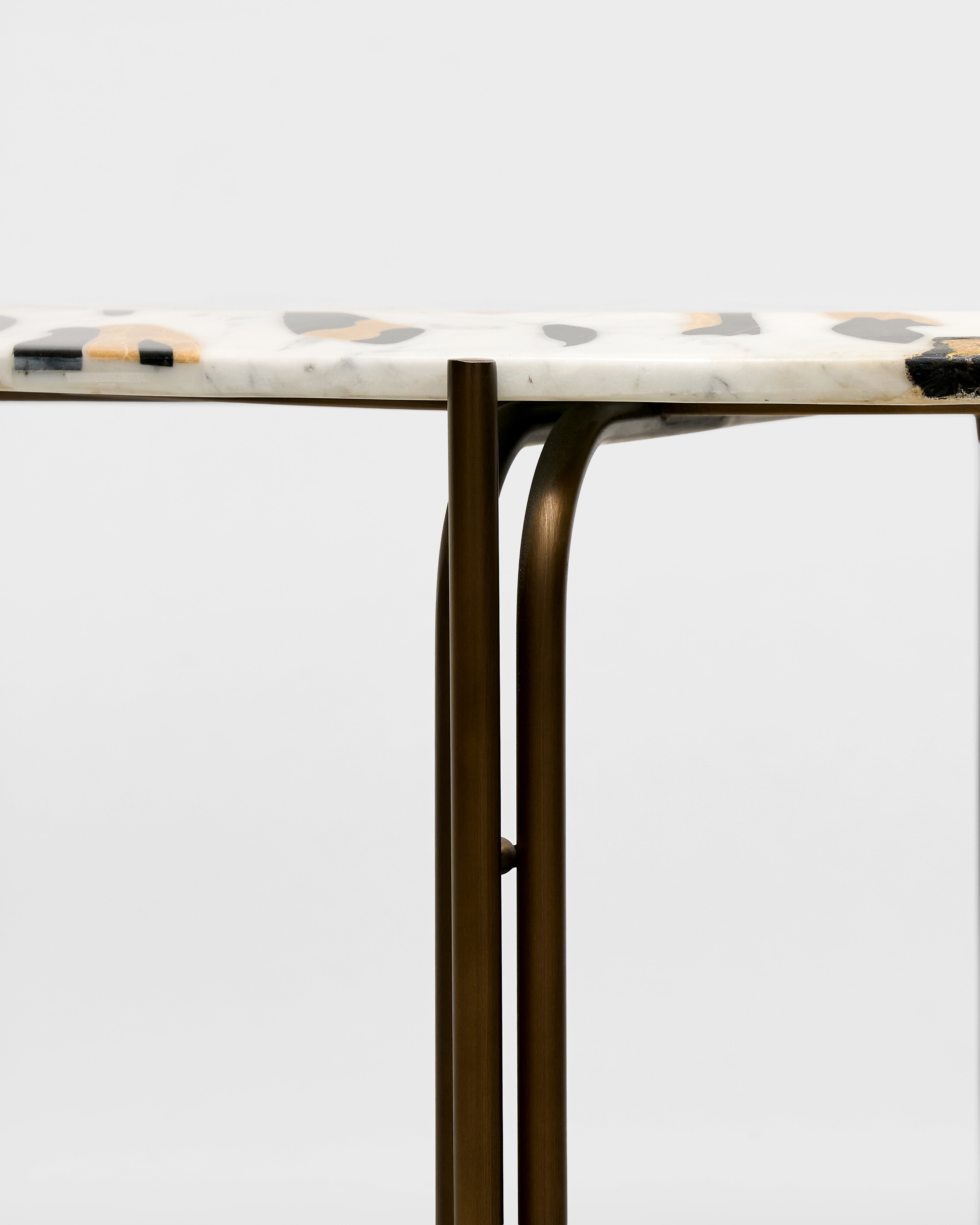 Marble-top table with bronze legs on a white background