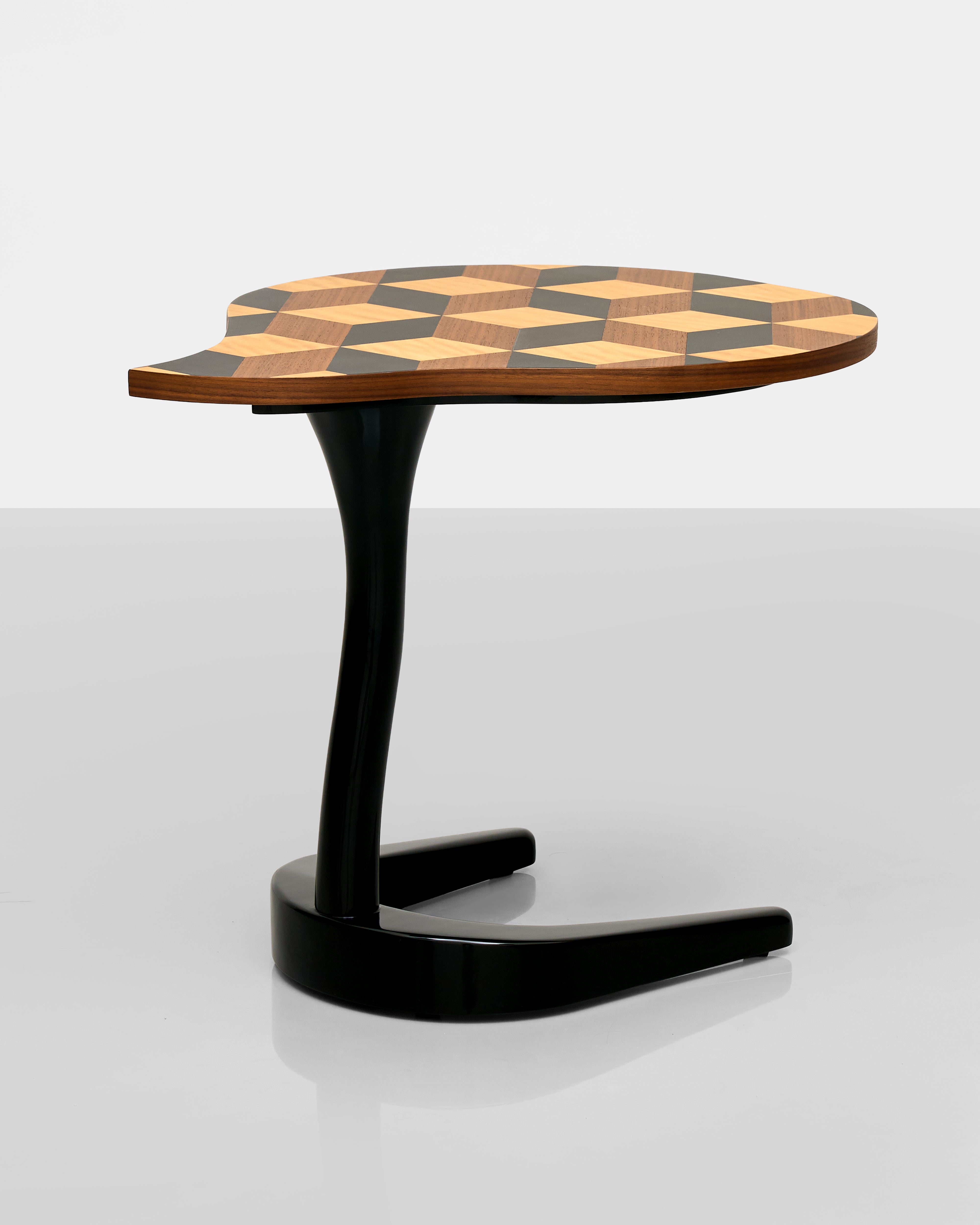 Modern side table with geometric-patterned top on a white background