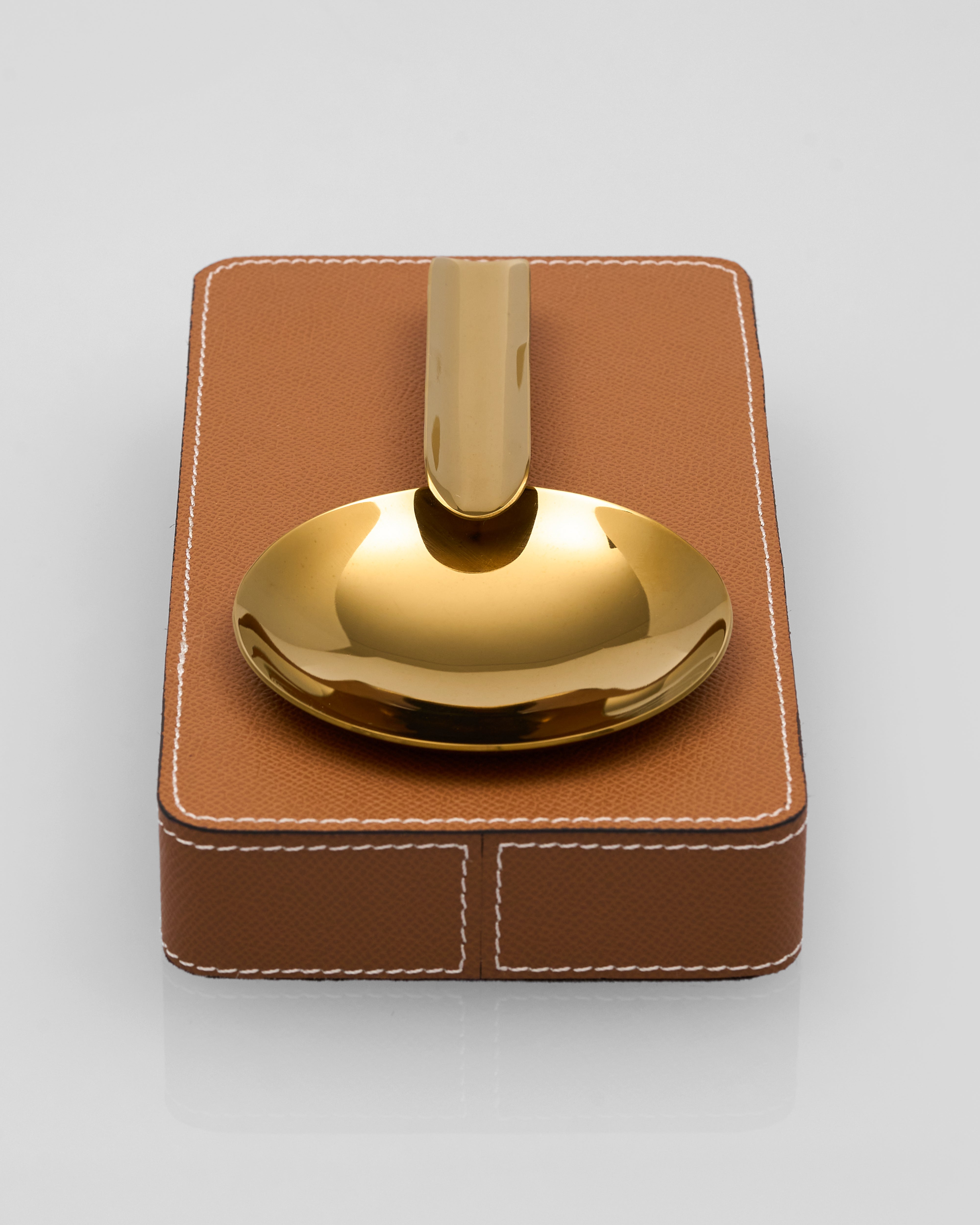 Gold Gelo Leather Ashtray brown leather holder against a light gray background
