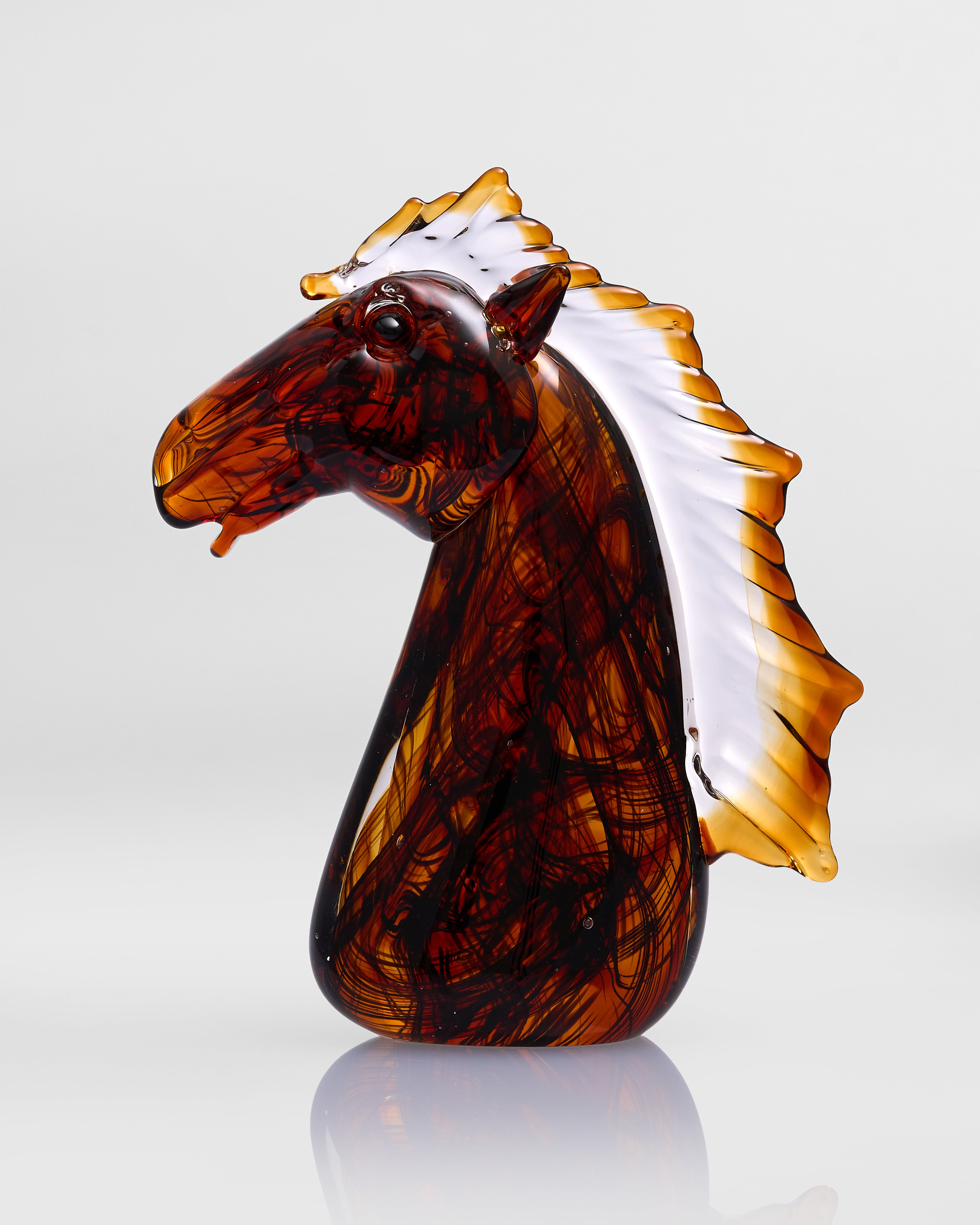 Glass horse head sculpture with a white background