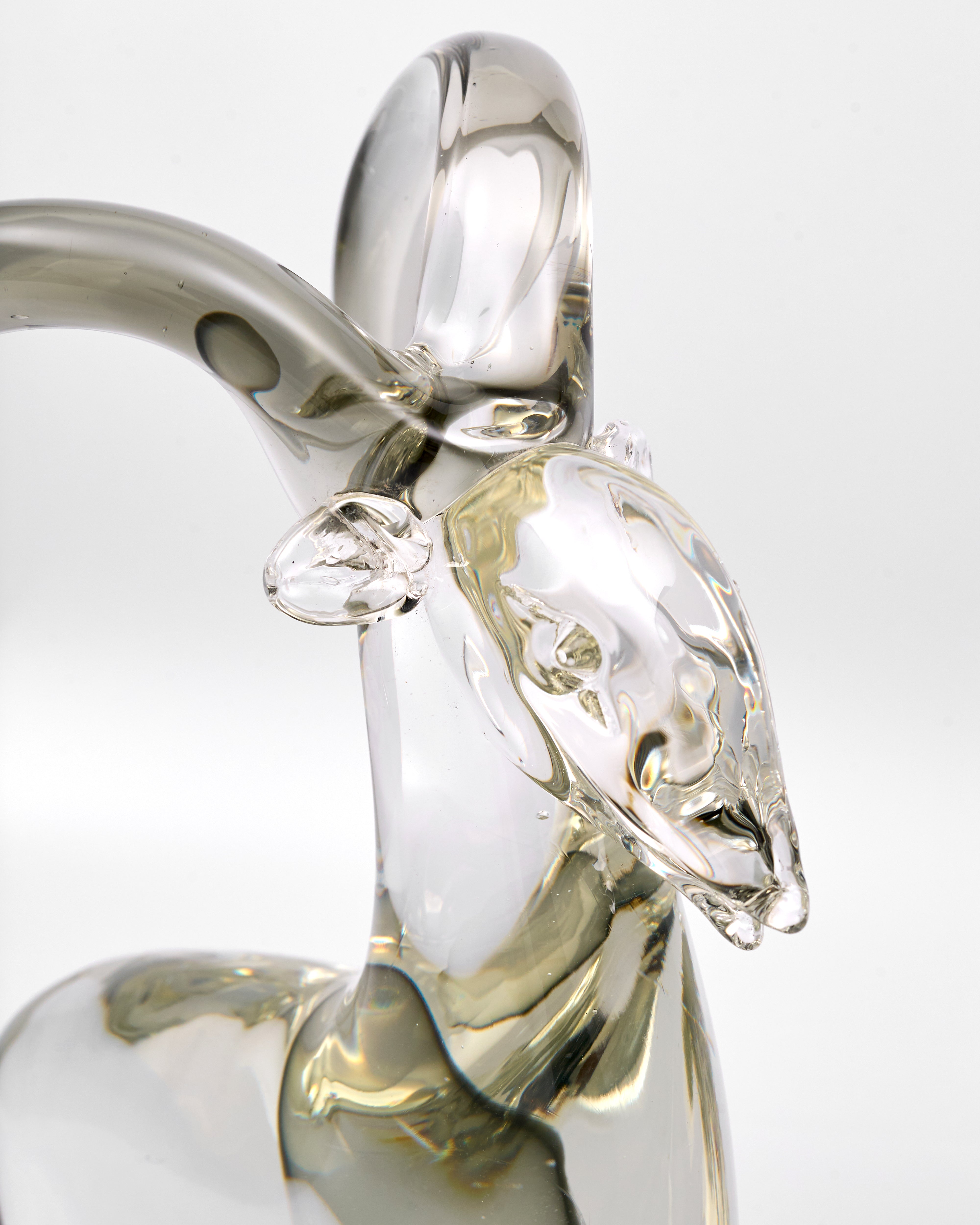 crystal glass sculpture of a goat on a white background