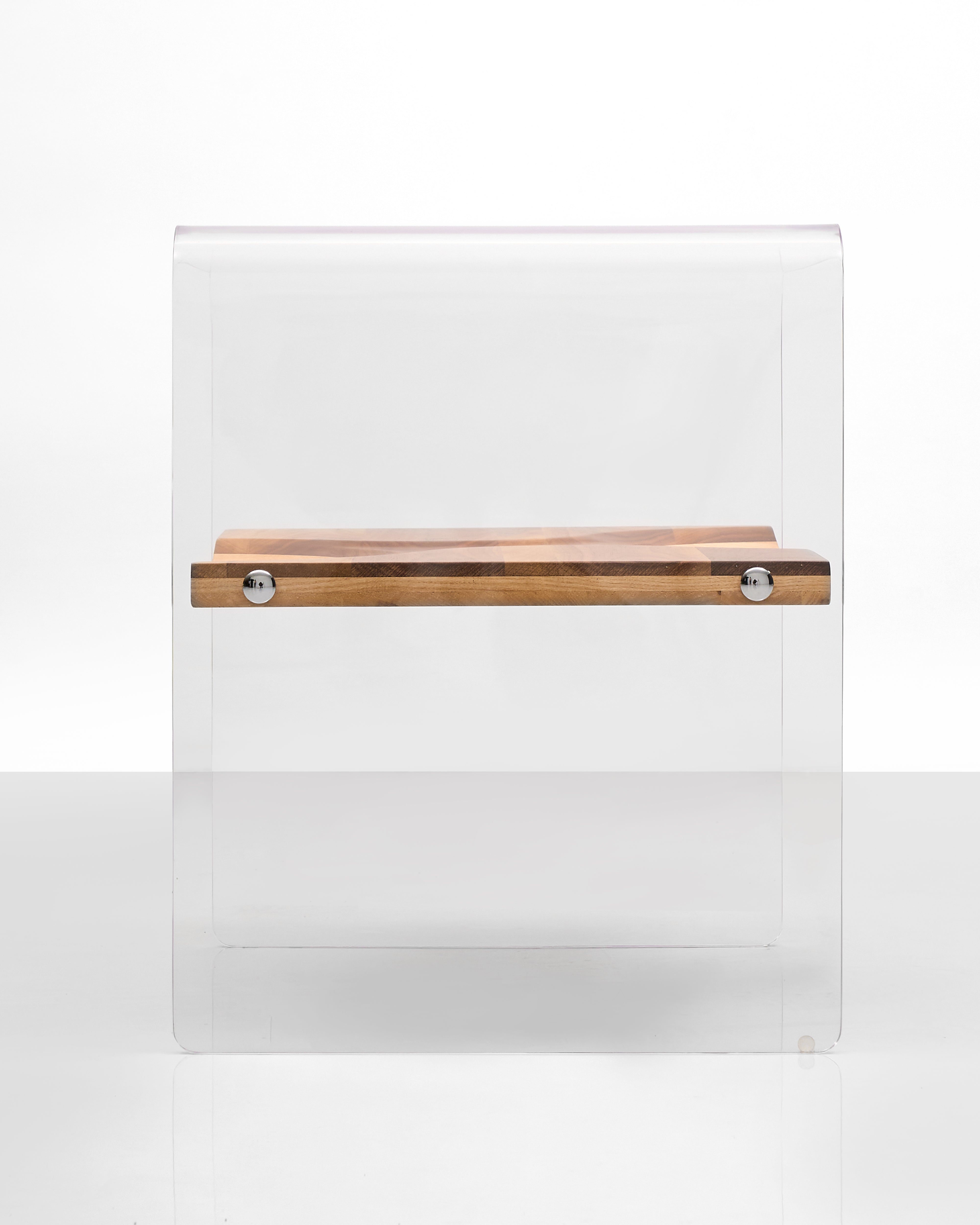 Clear glass cutting board with a wooden handle on a white background