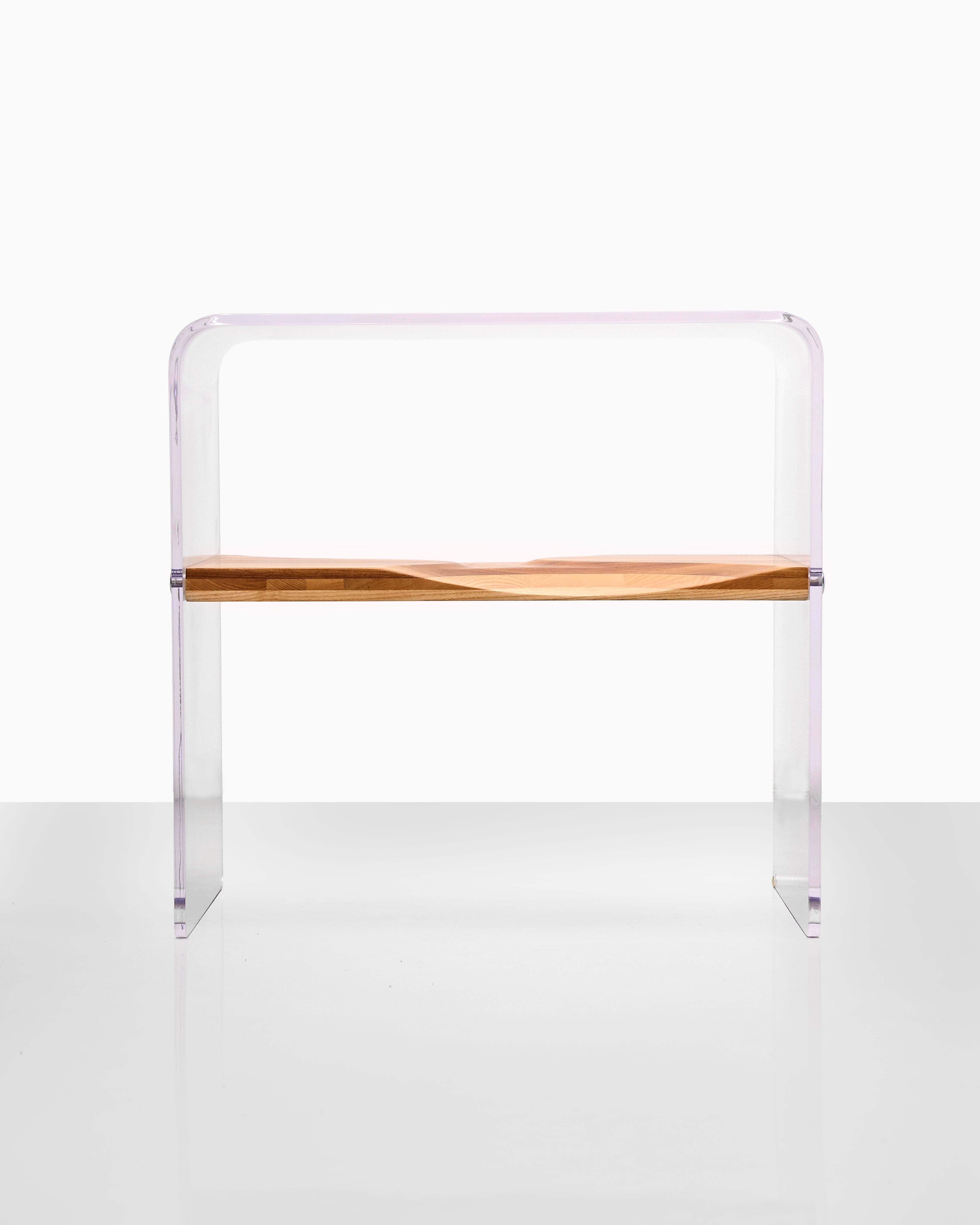 Clear acrylic bench with wooden seat on a white background