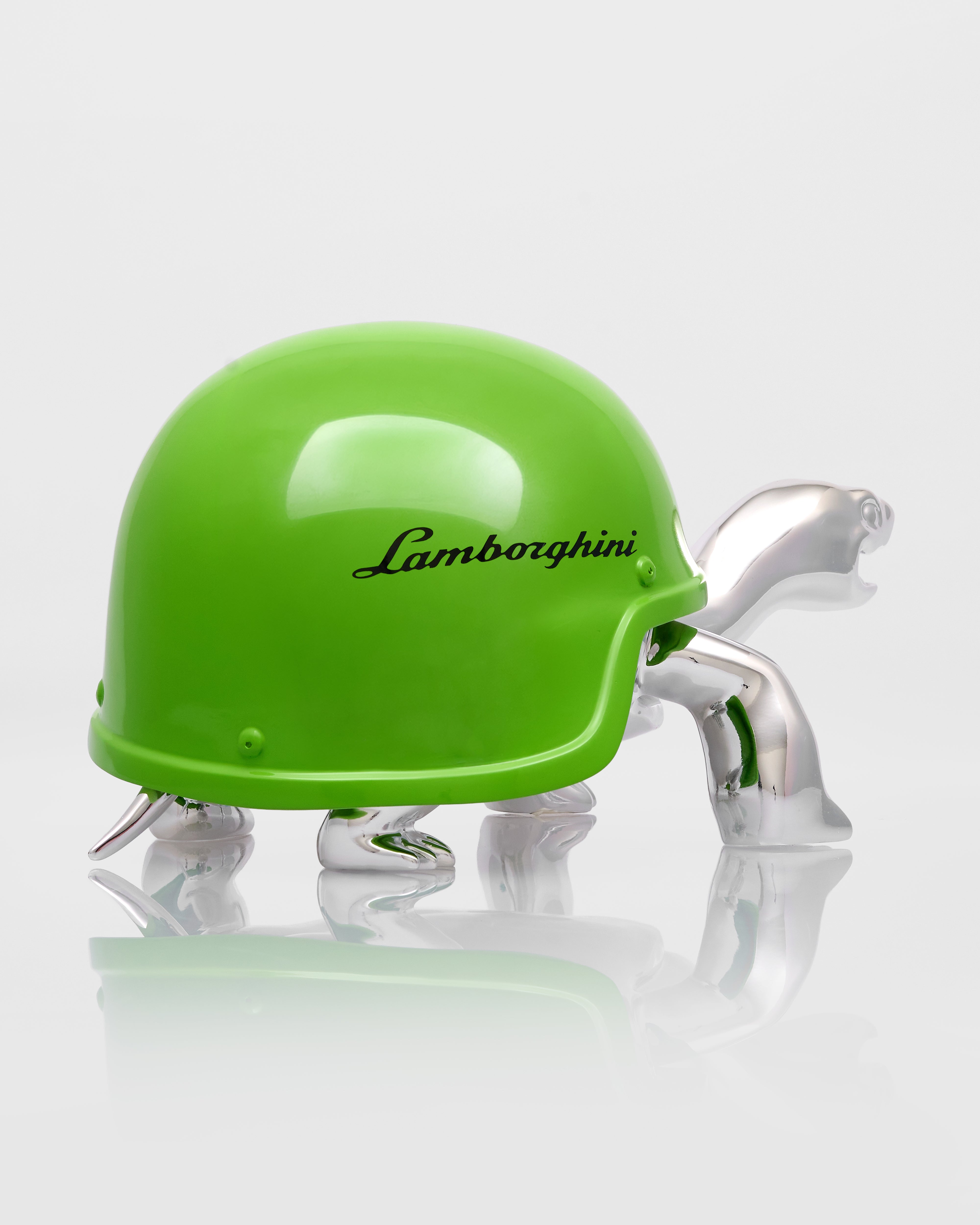 Green helmet with 'Lamborghini' branding on a reflective surface