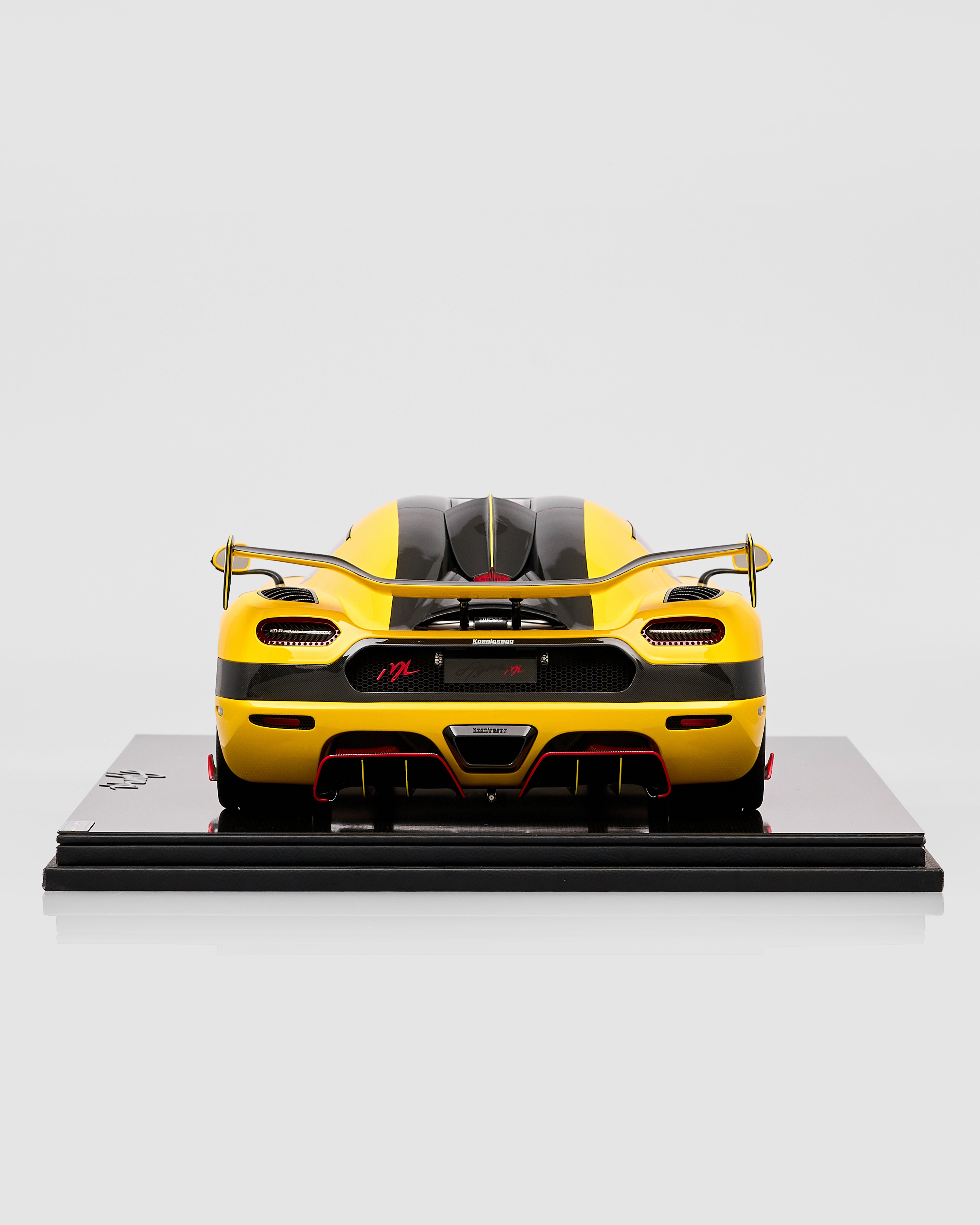 Yellow and black model car on a gray background