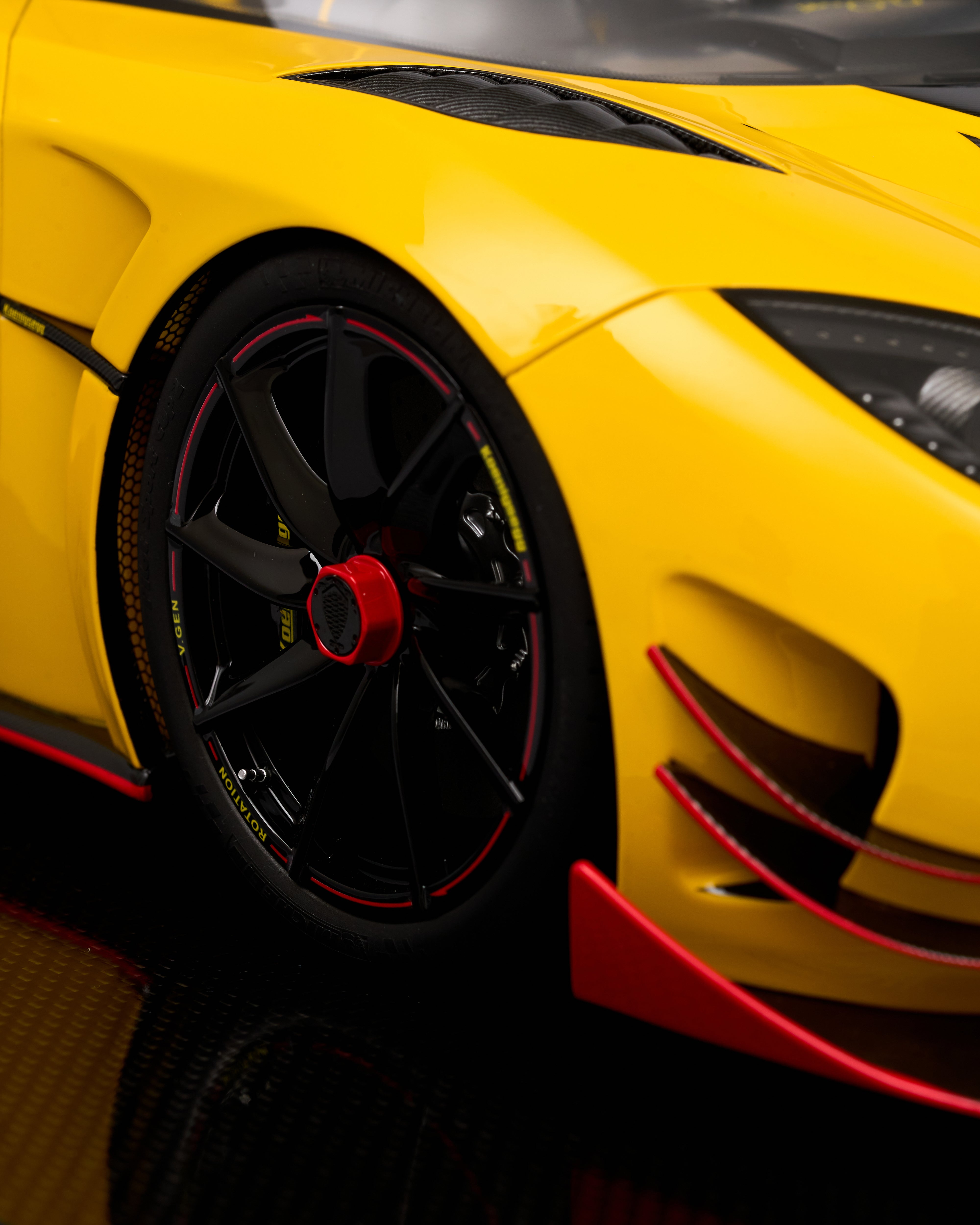 Close-up of a yellow sports car with black and red details