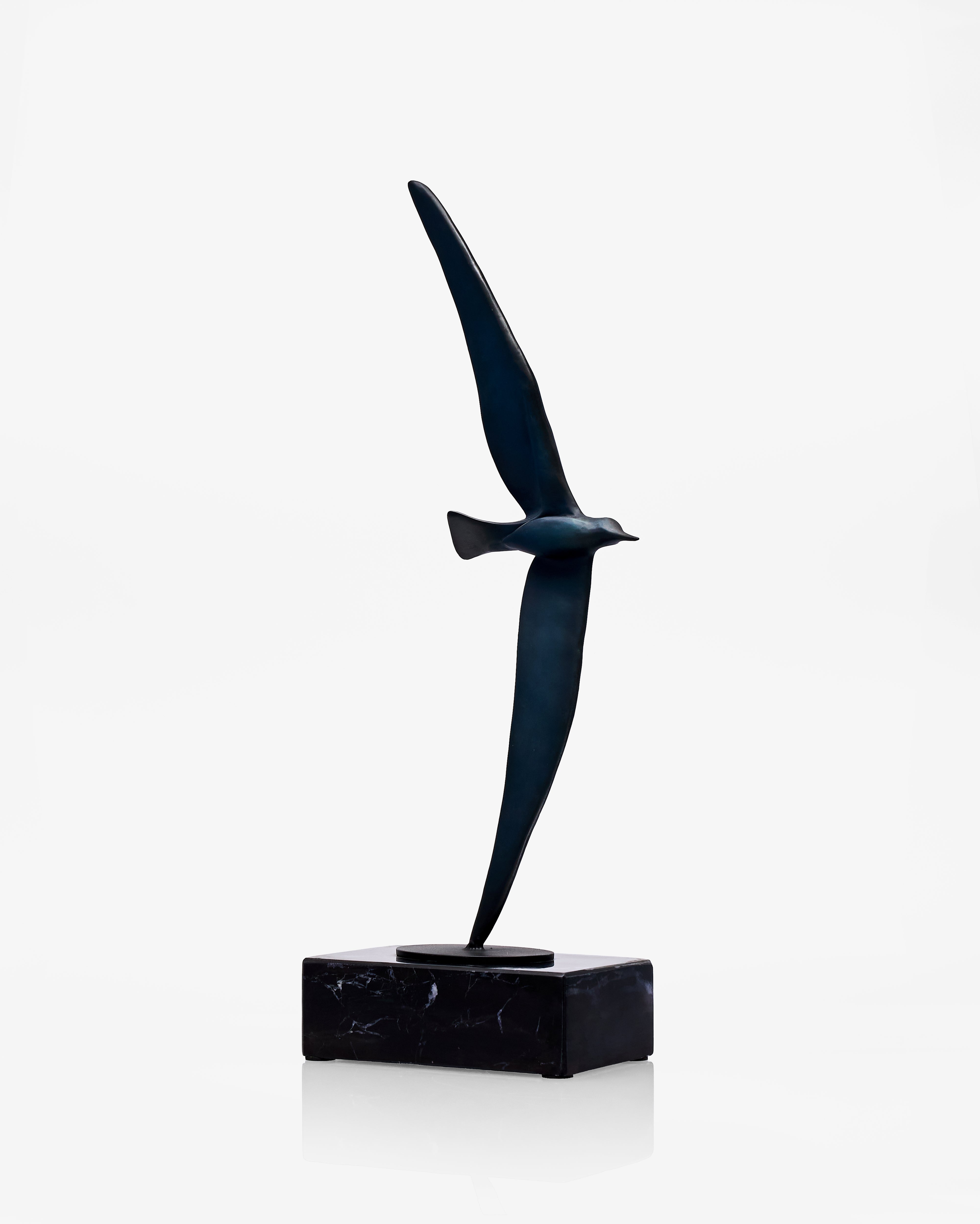 Black abstract bird sculpture on a white background