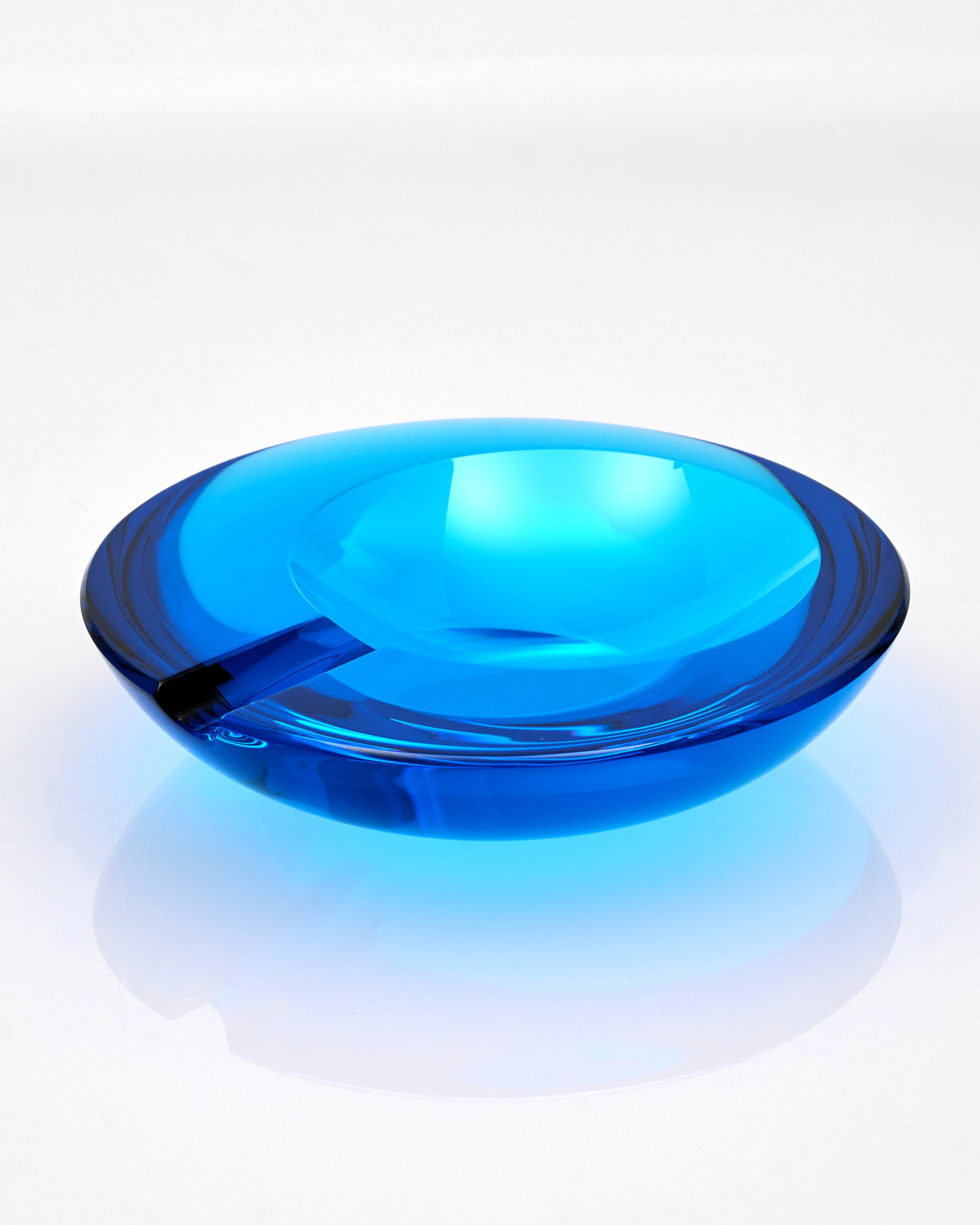 Blue glass ashtray on a white background