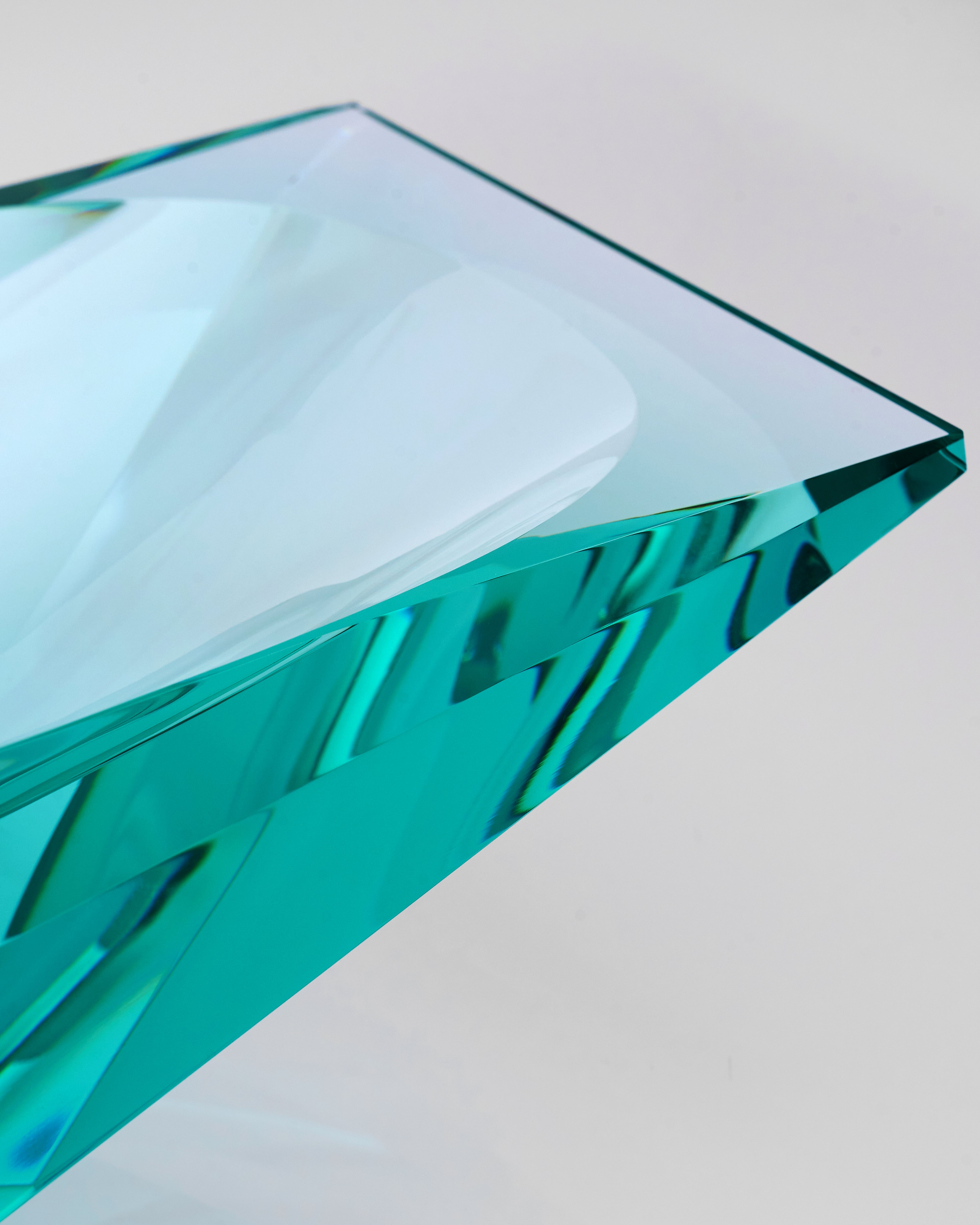 Teal glass object on a white background