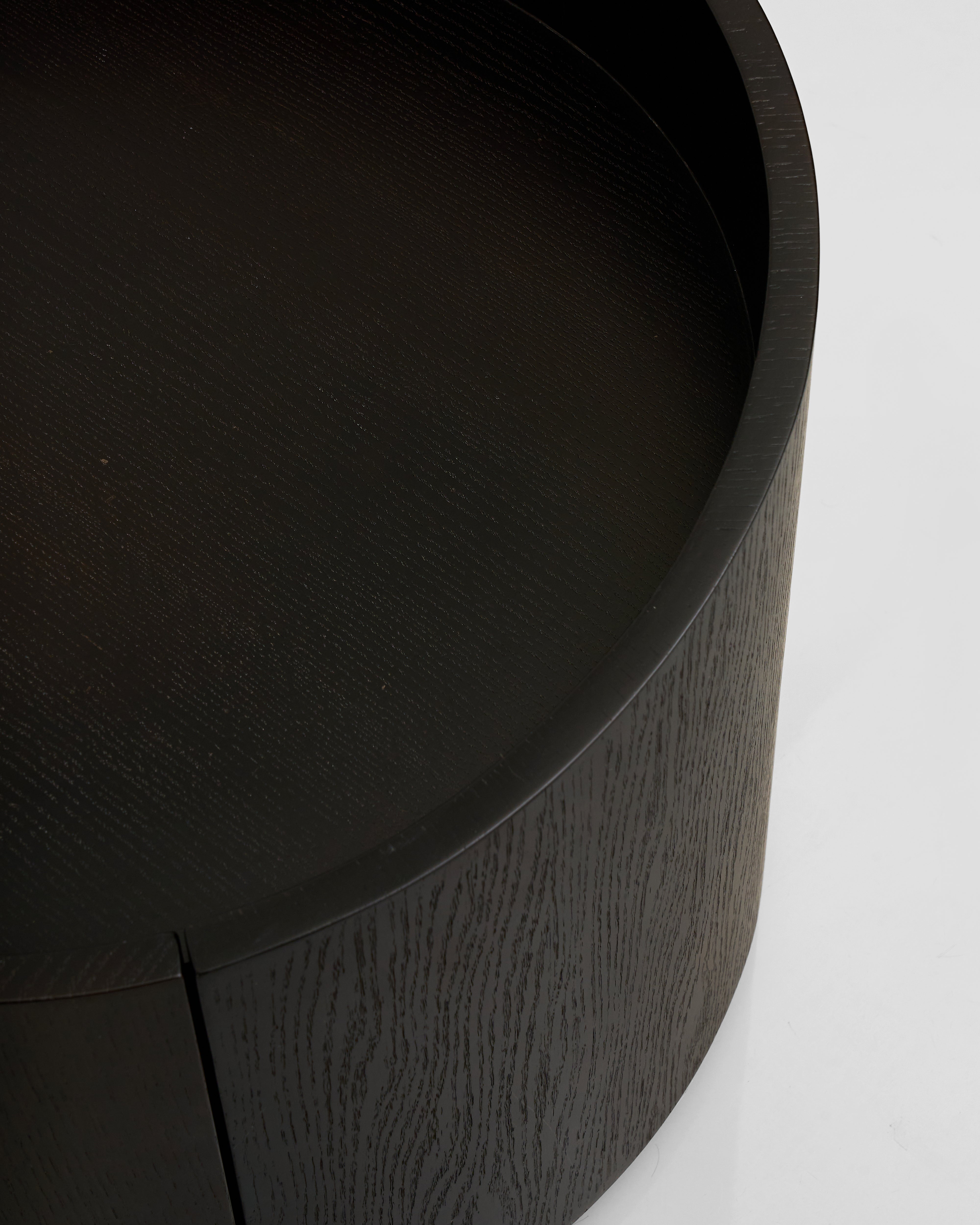 Close-up of a black cylindrical object with a textured surface on a white background