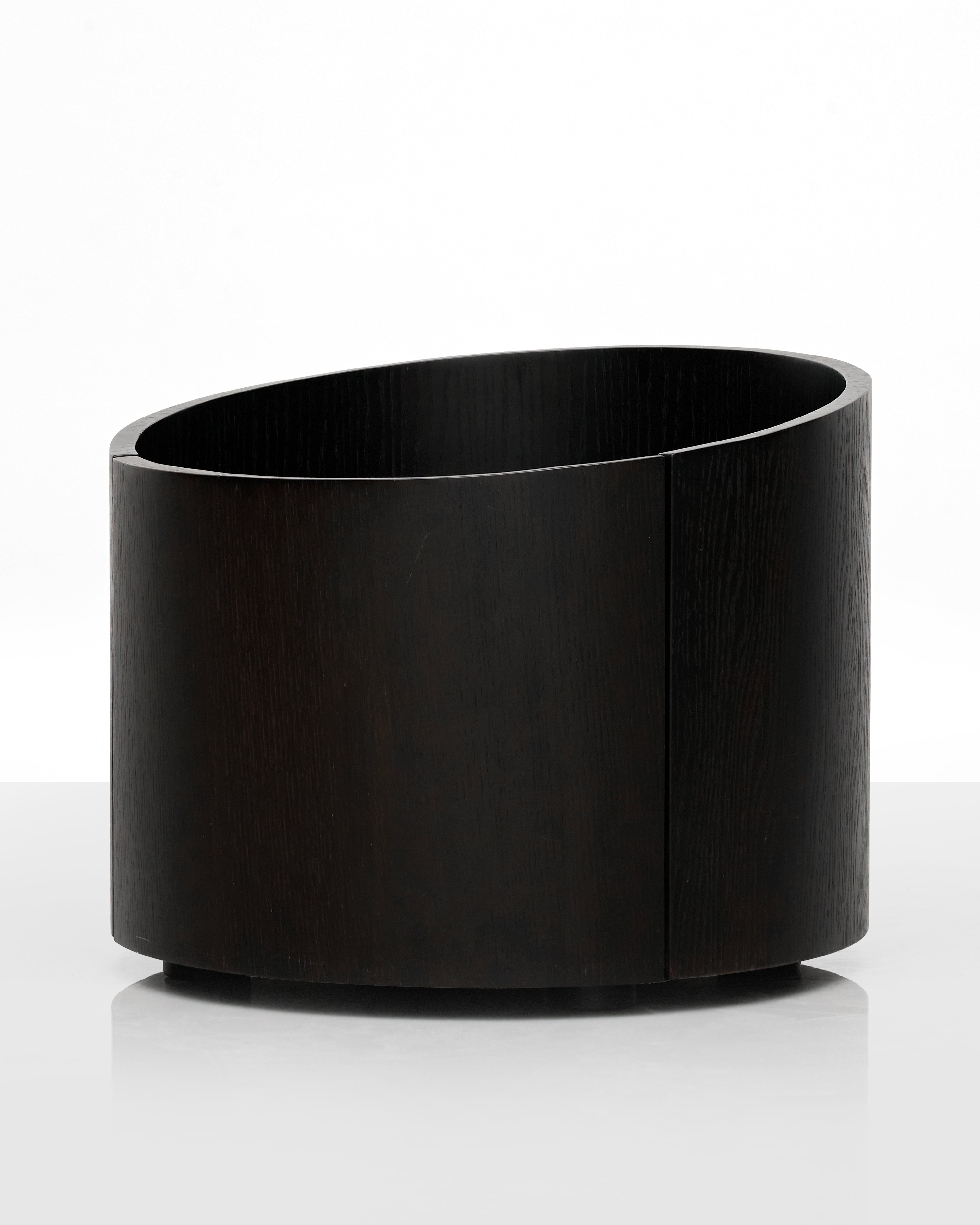 Black cylindrical side table on a white background
