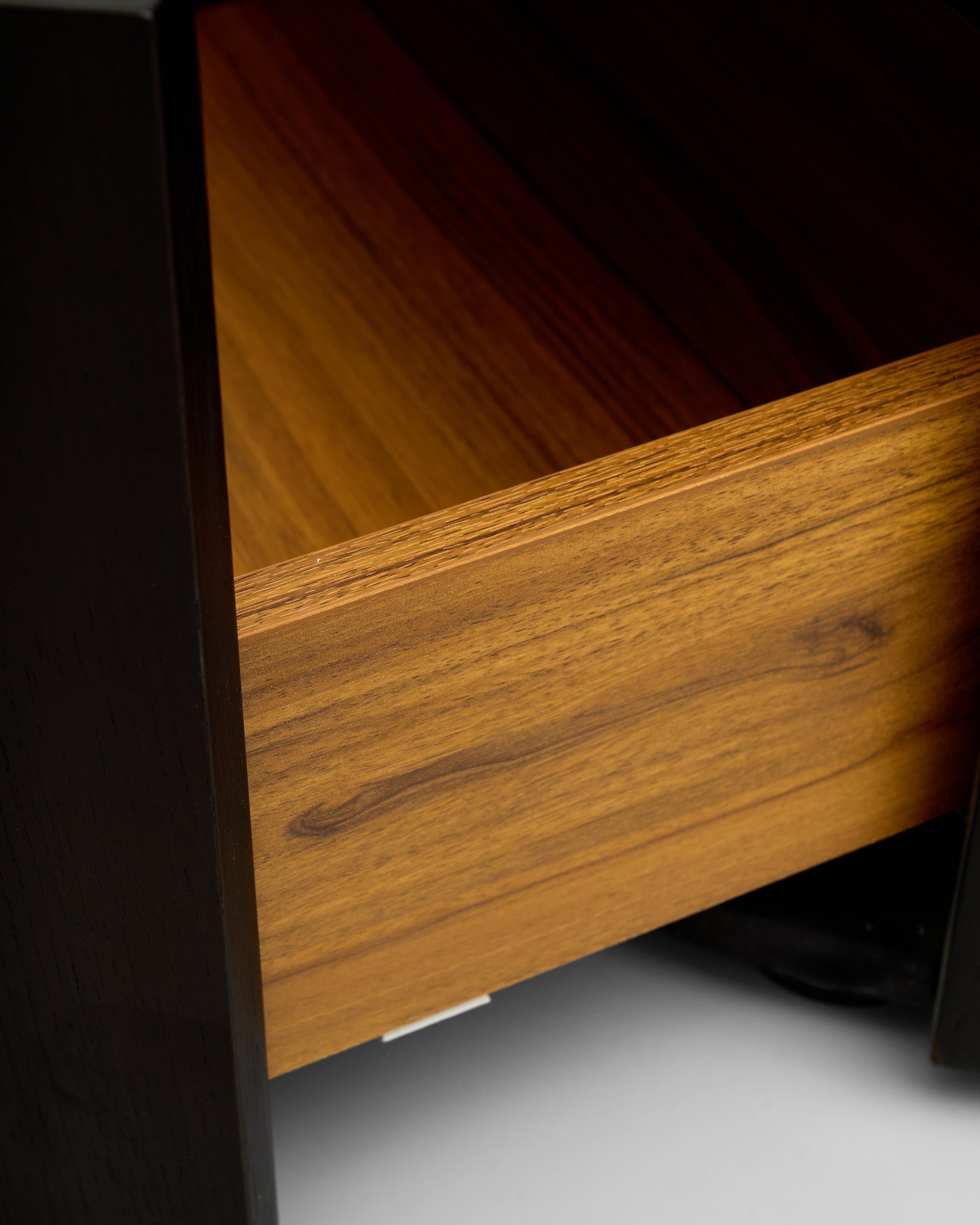 Close-up of a wooden drawer with a dark background