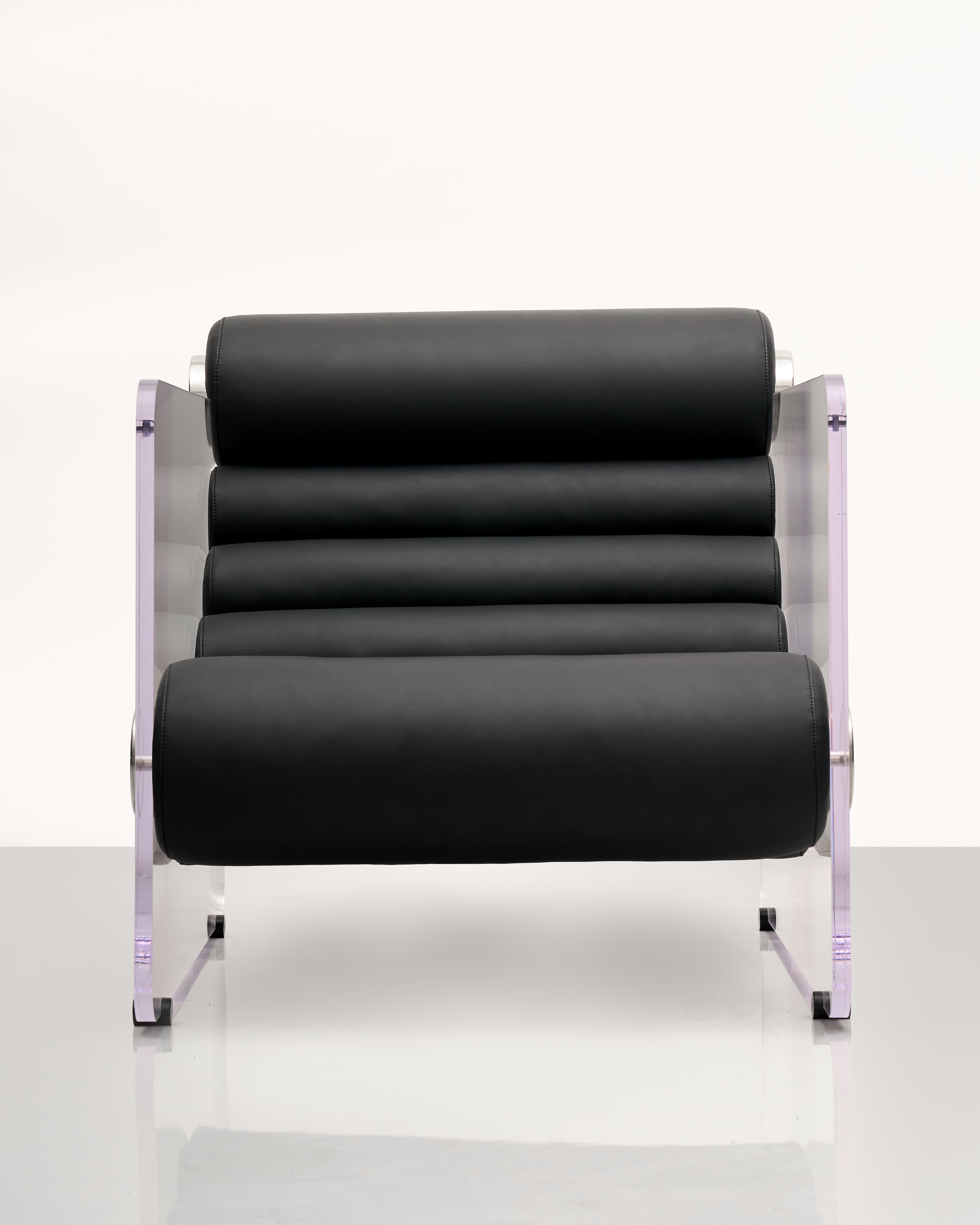 Black lounge chair with acrylic side  frame on a white background