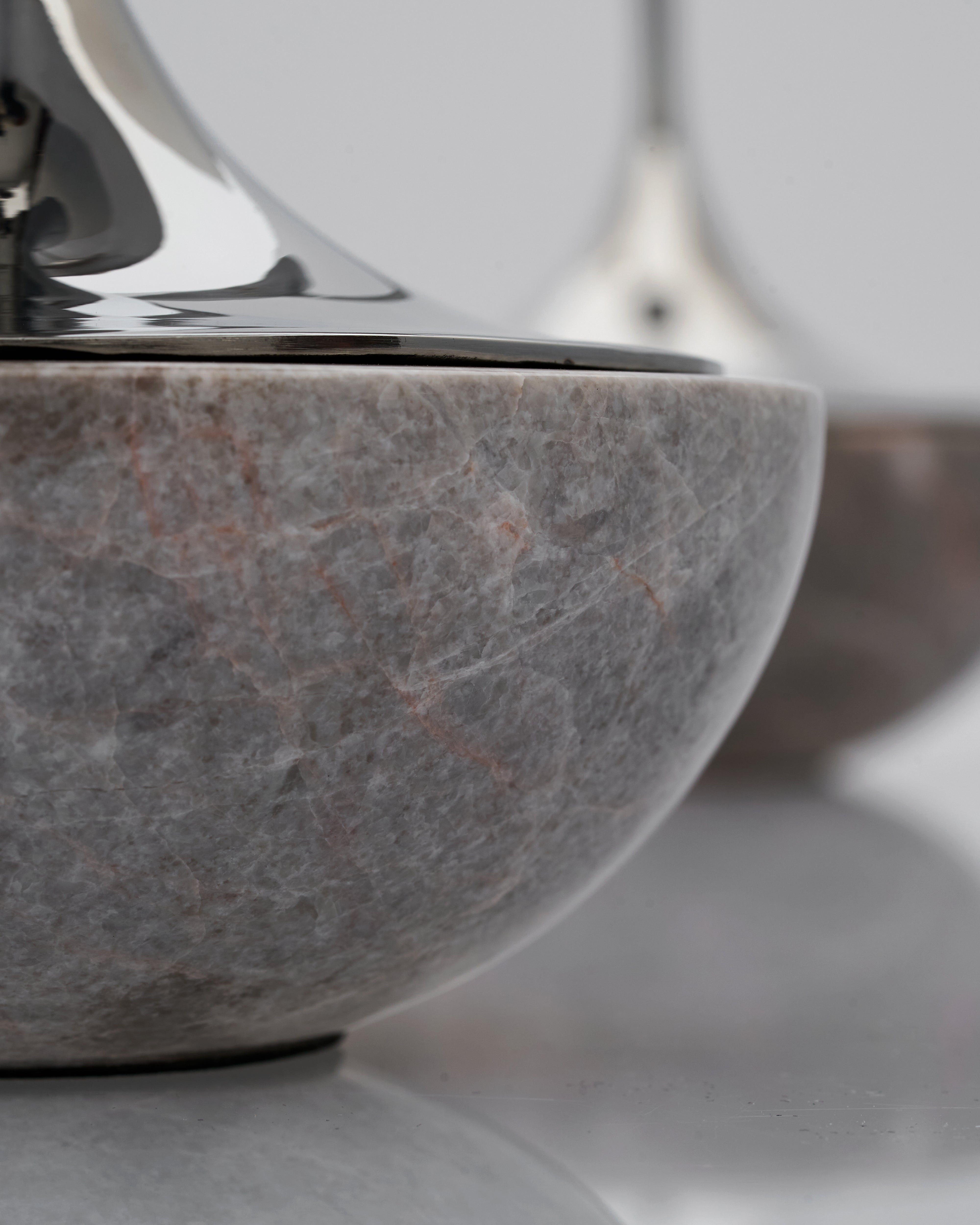Close-up of a marble base of a stainless steel candle holder