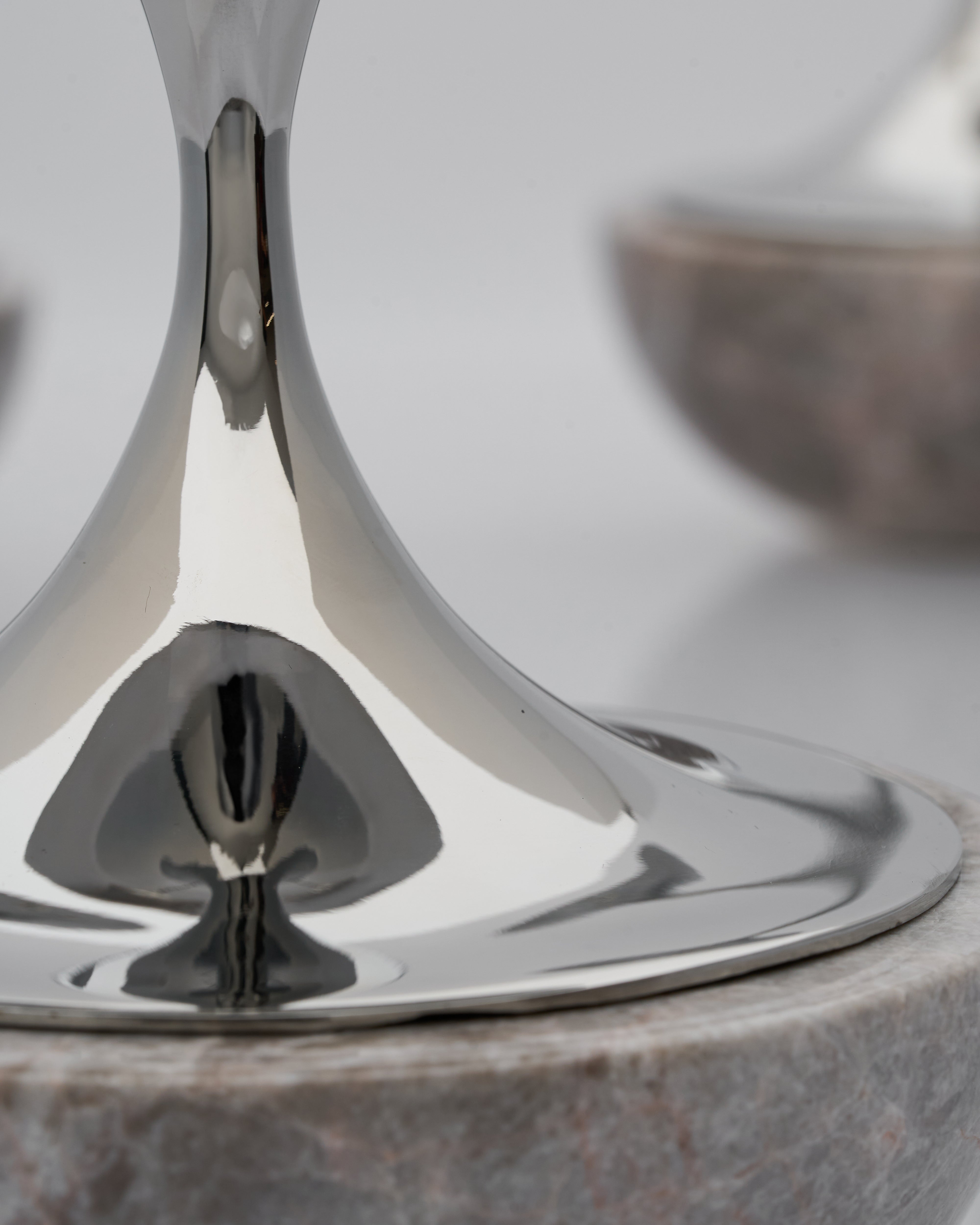 Close-up of a silver candle  holder with a marble surface