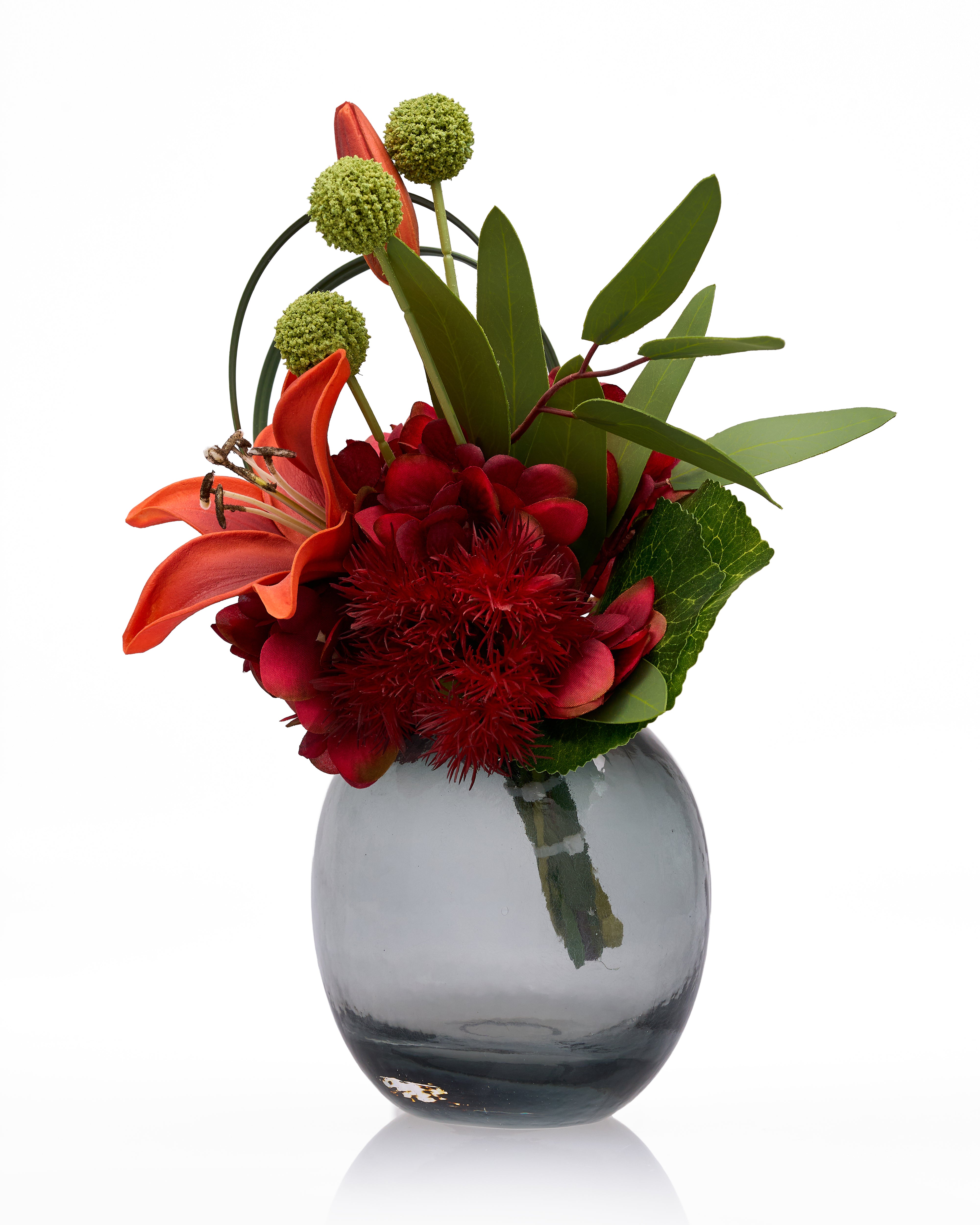 Floral arrangement in a clear vase on a white background