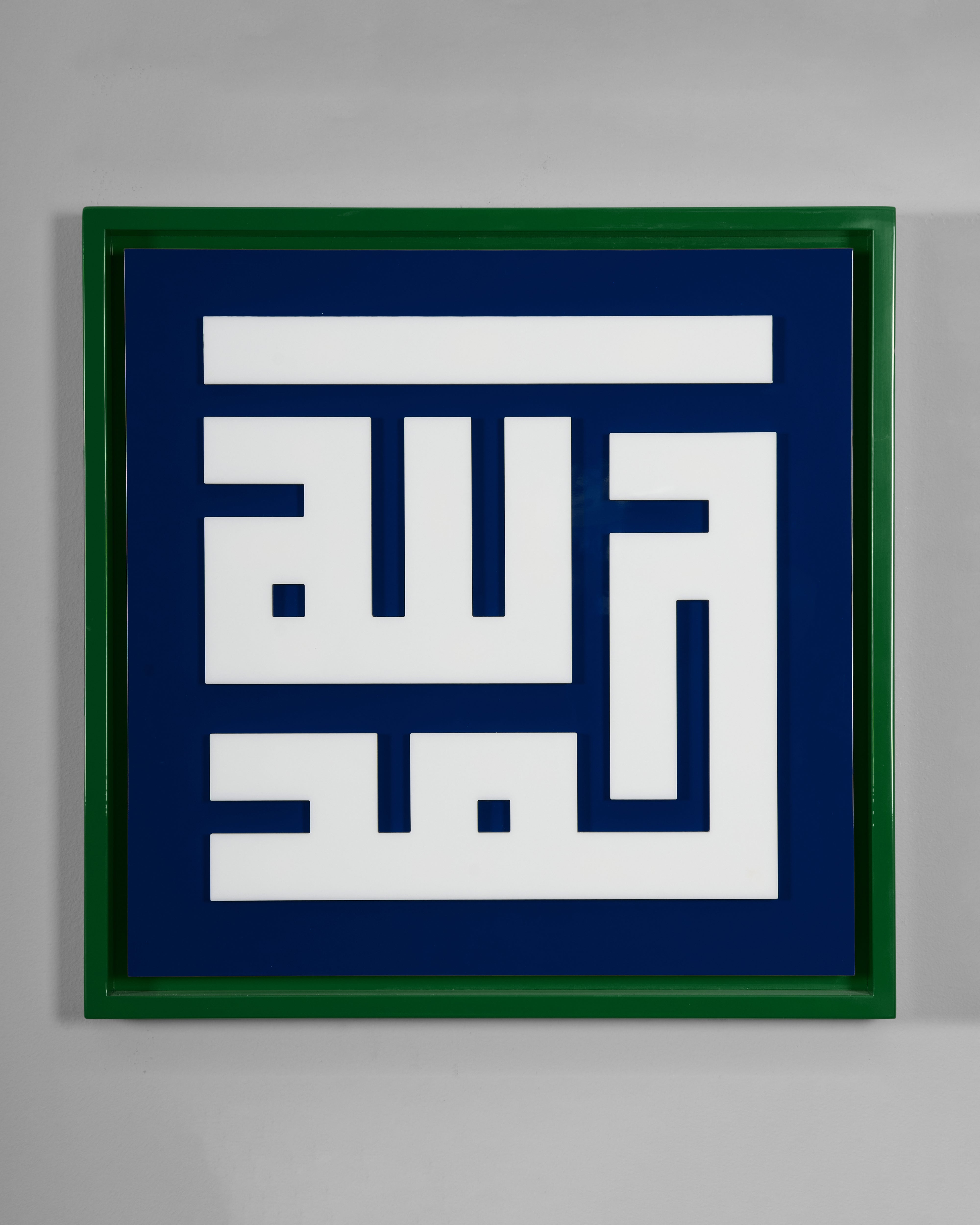 Framed artwork with white geometric design on a blue background