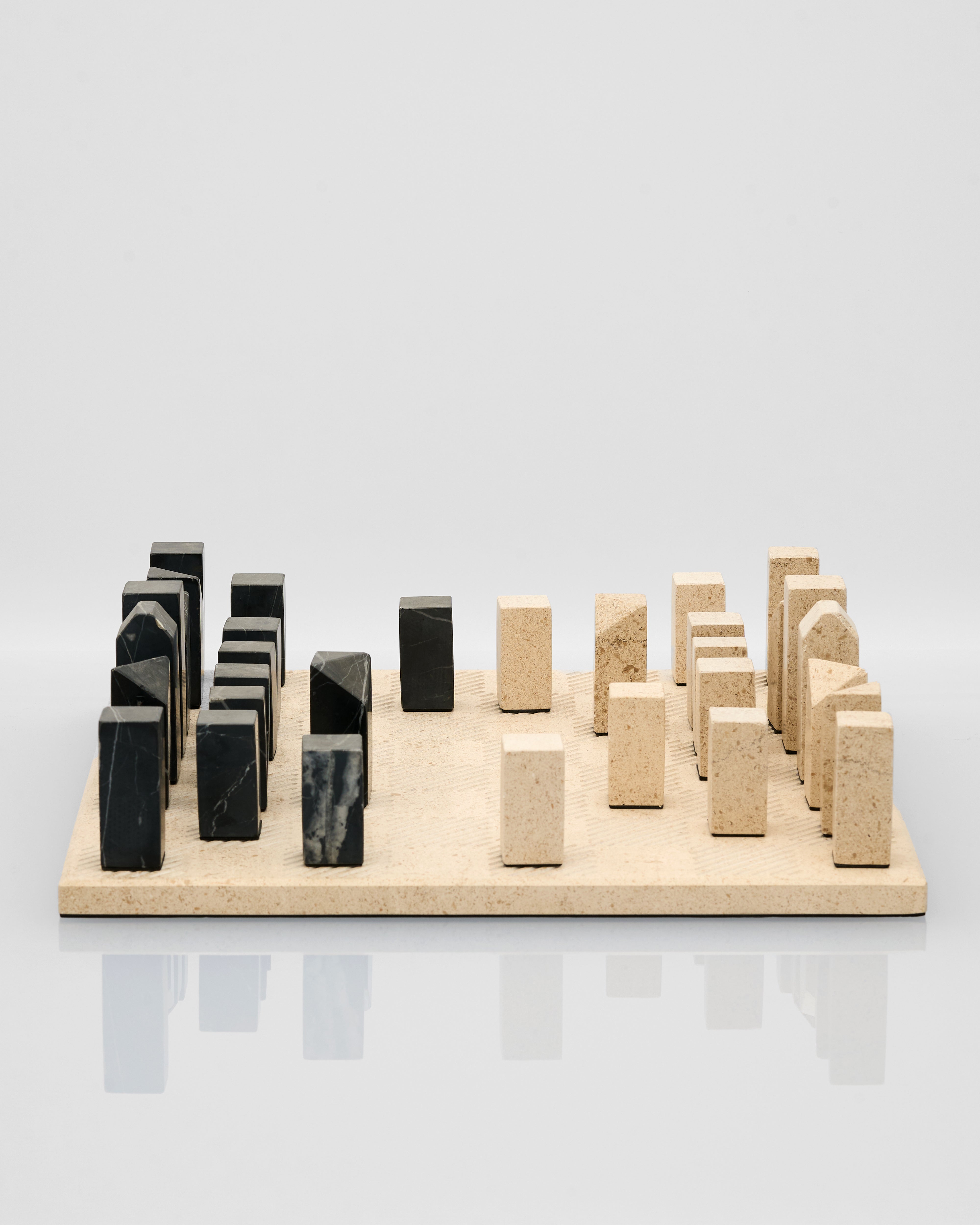 Set of marble and onyx blocks  of a chess board on a light gray background