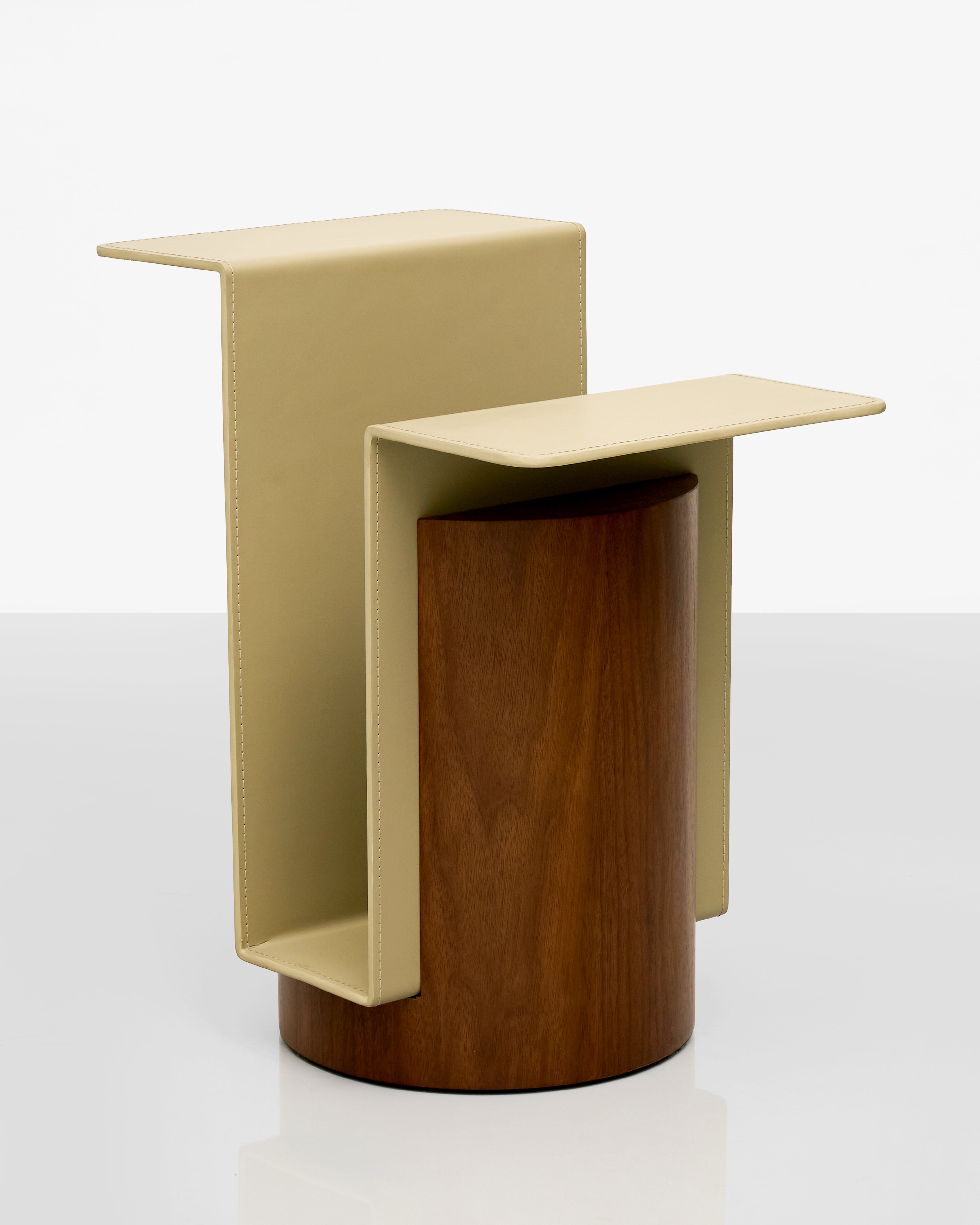 Modern side table with beige top and brown cylindrical base on a white background