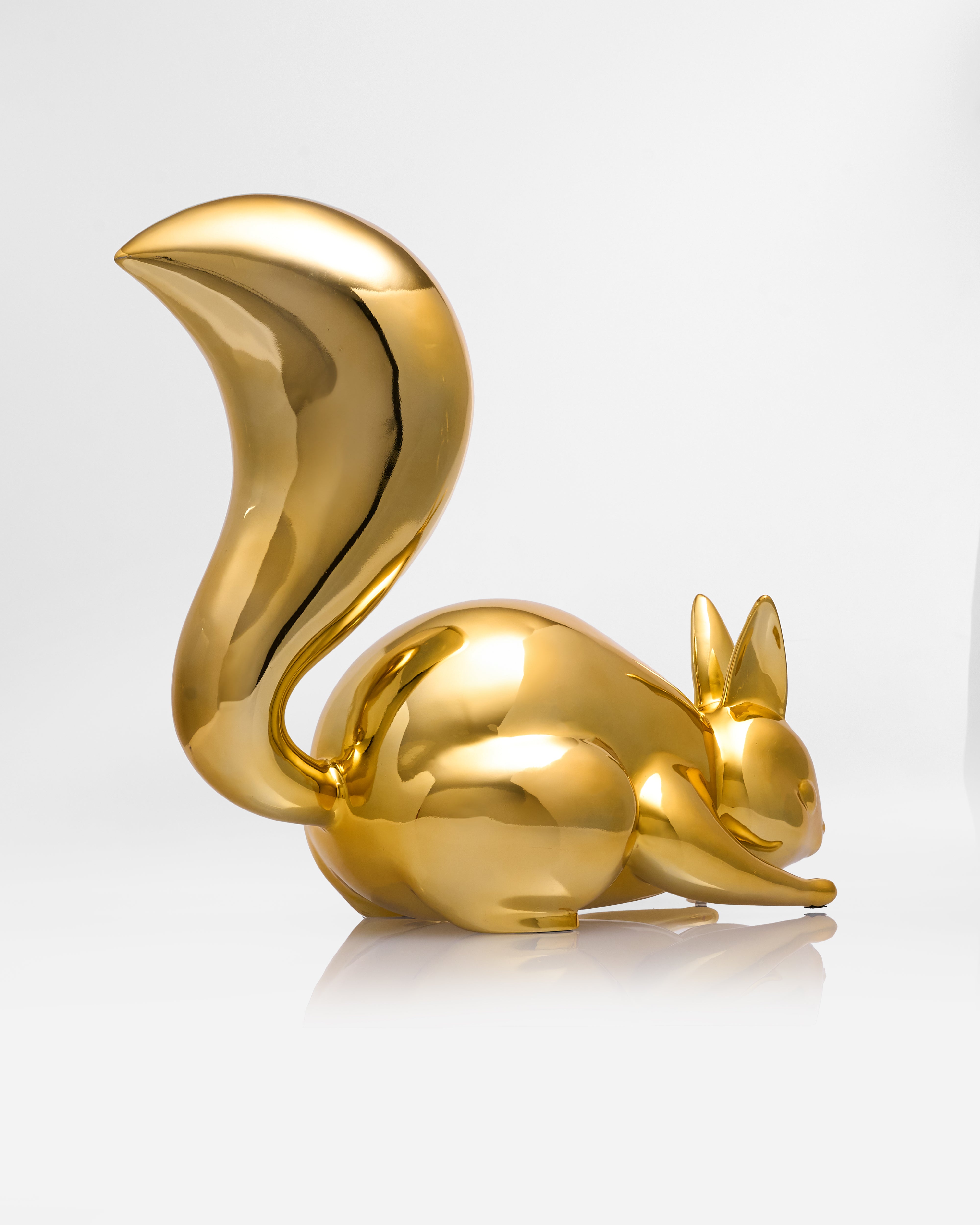 Gold rabbit figurine on a white background