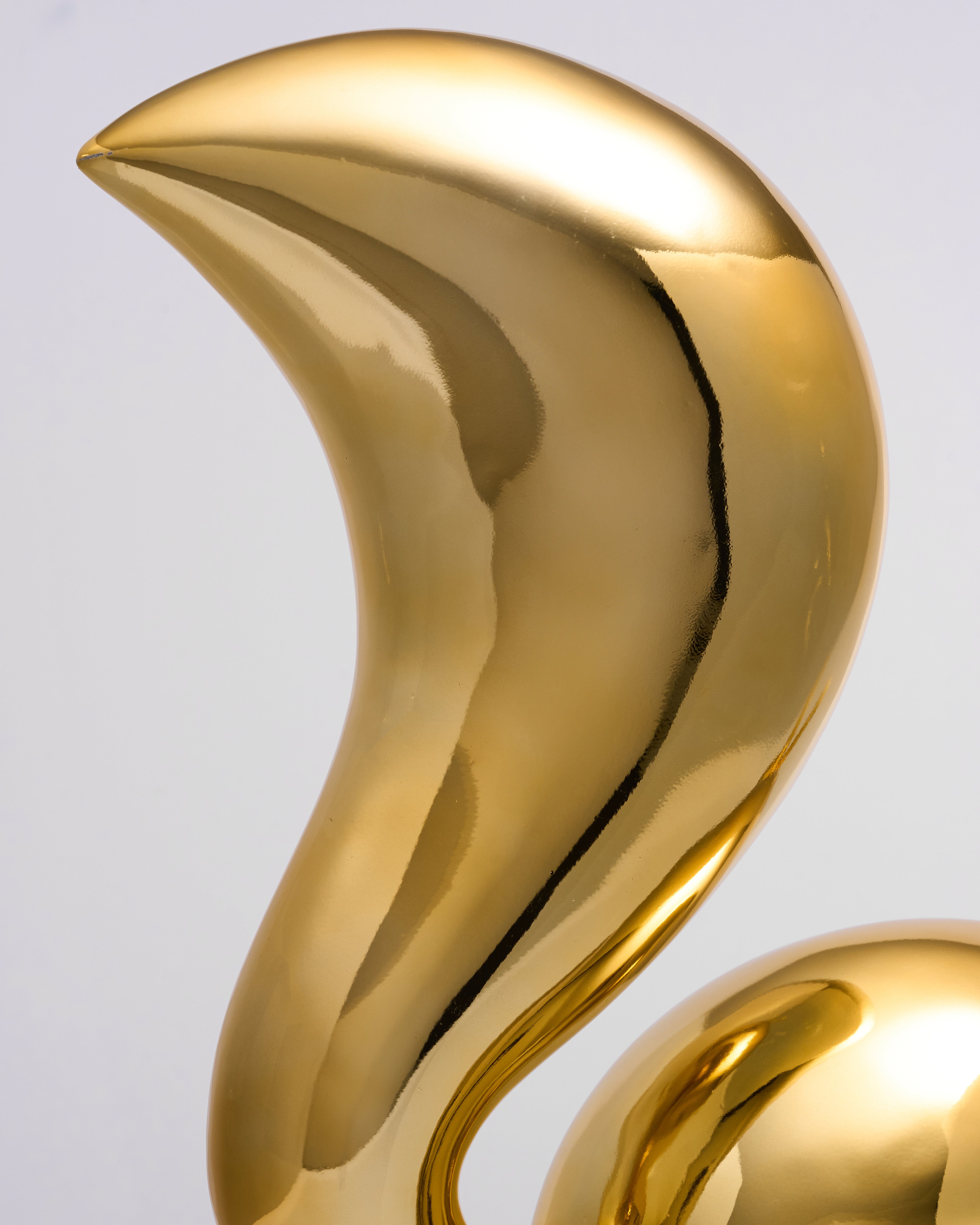 Gold decorative Minimalist Golden Rabbit Decor with a curved design on a light gray background