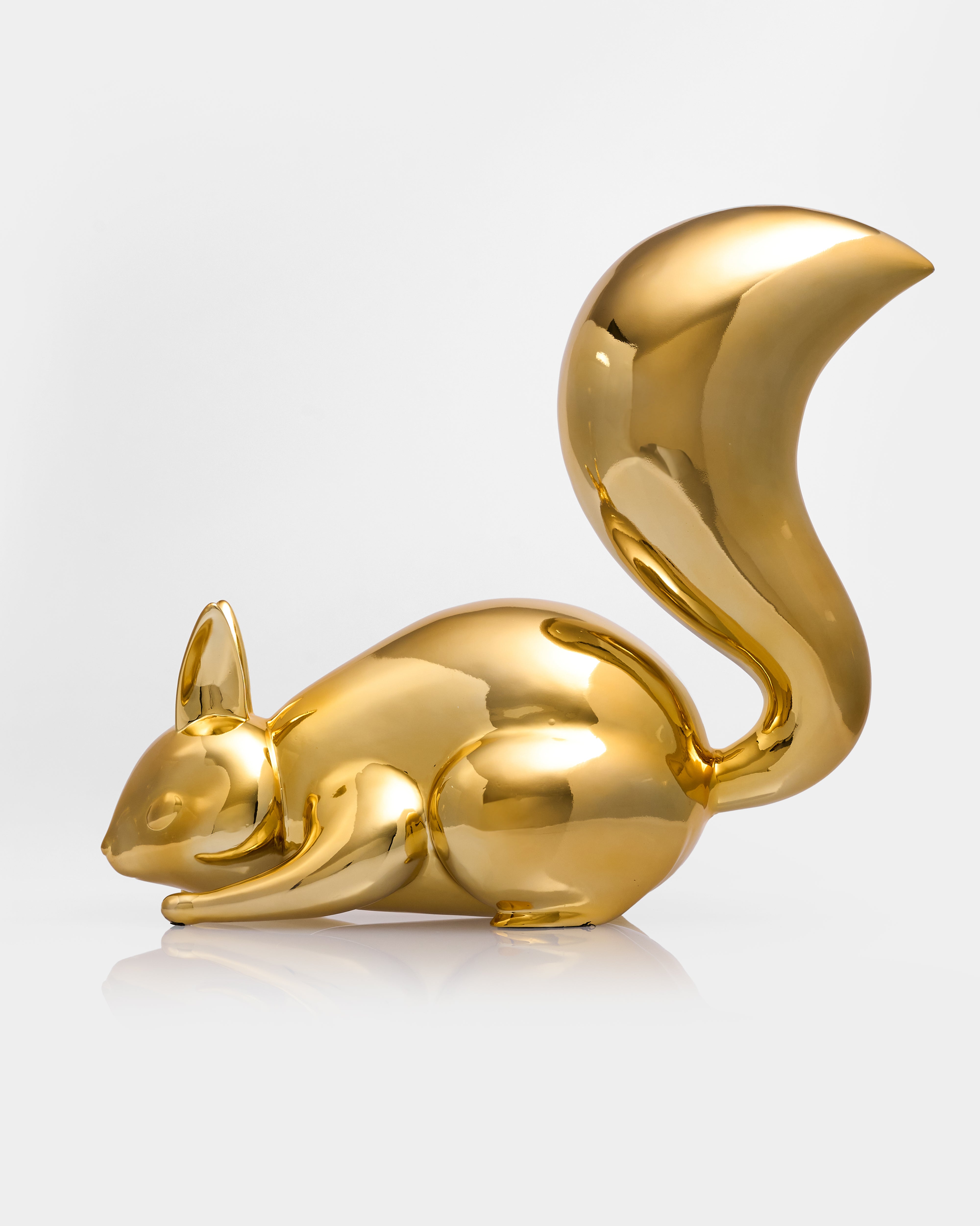 Gold rabbit figurine on a white background