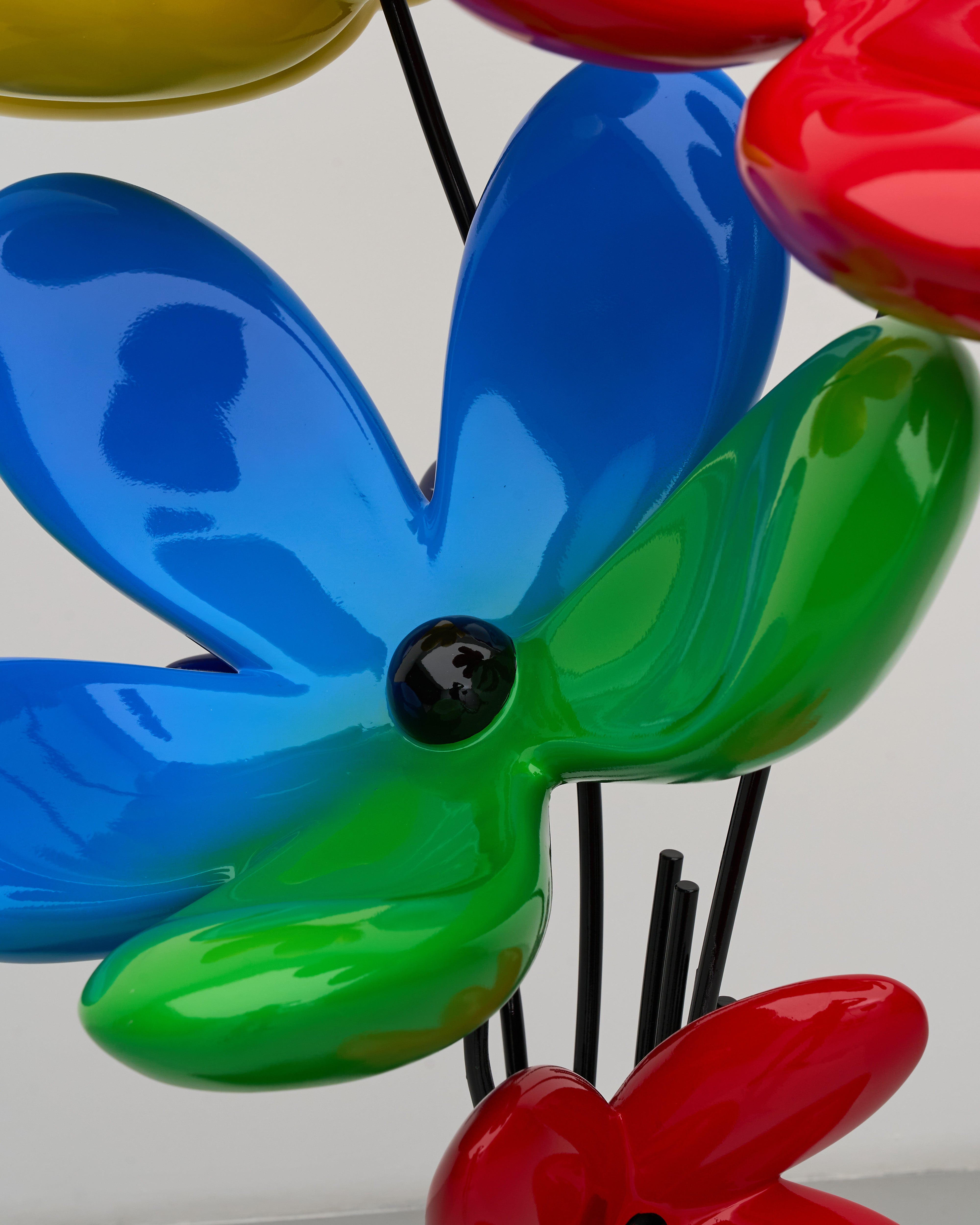 Colorful flower-shaped objects in blue, green, and red on a white background