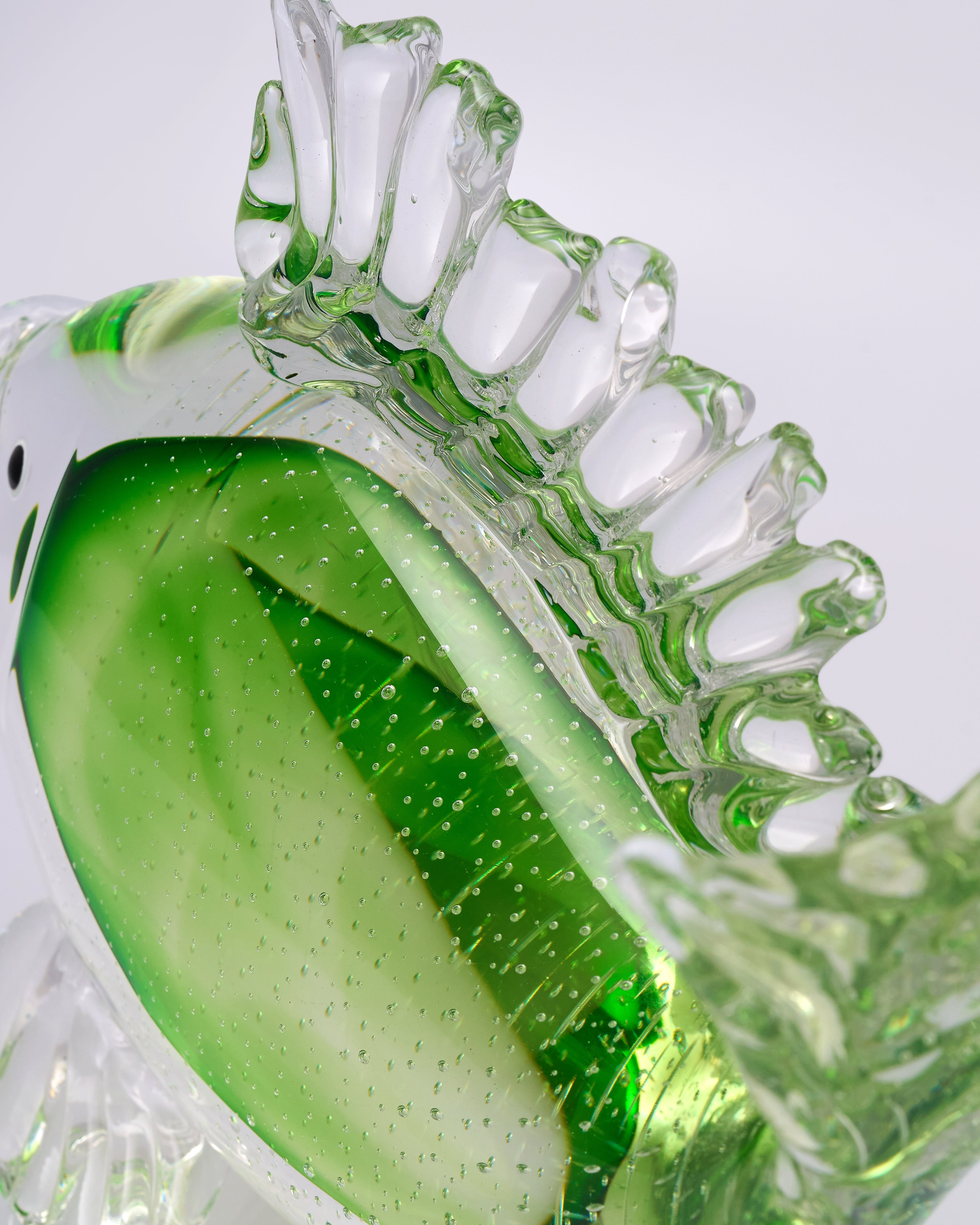 Clear glass material model with green silicone material on a white background