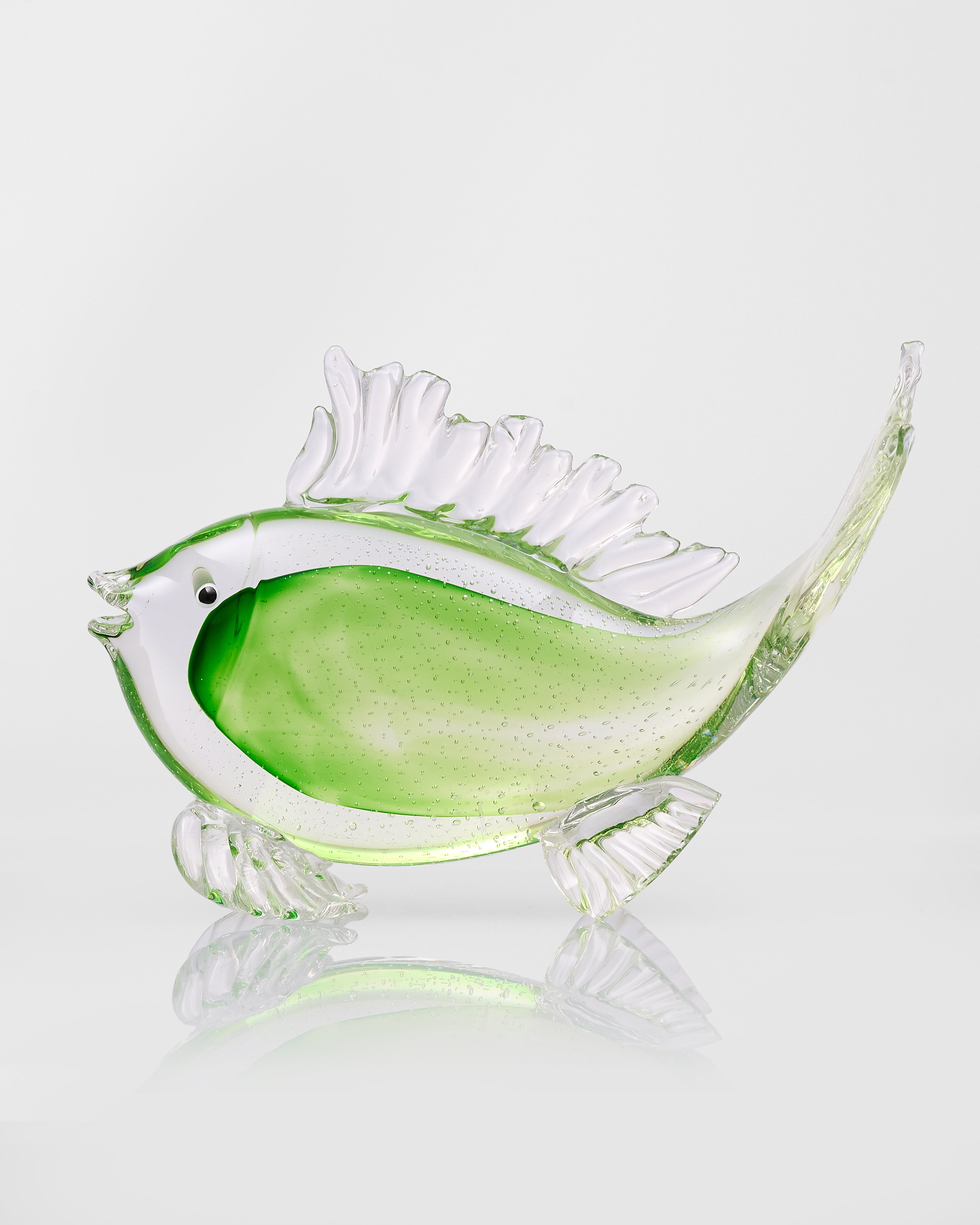 Green Glass fish sculpture with a green body on a white background