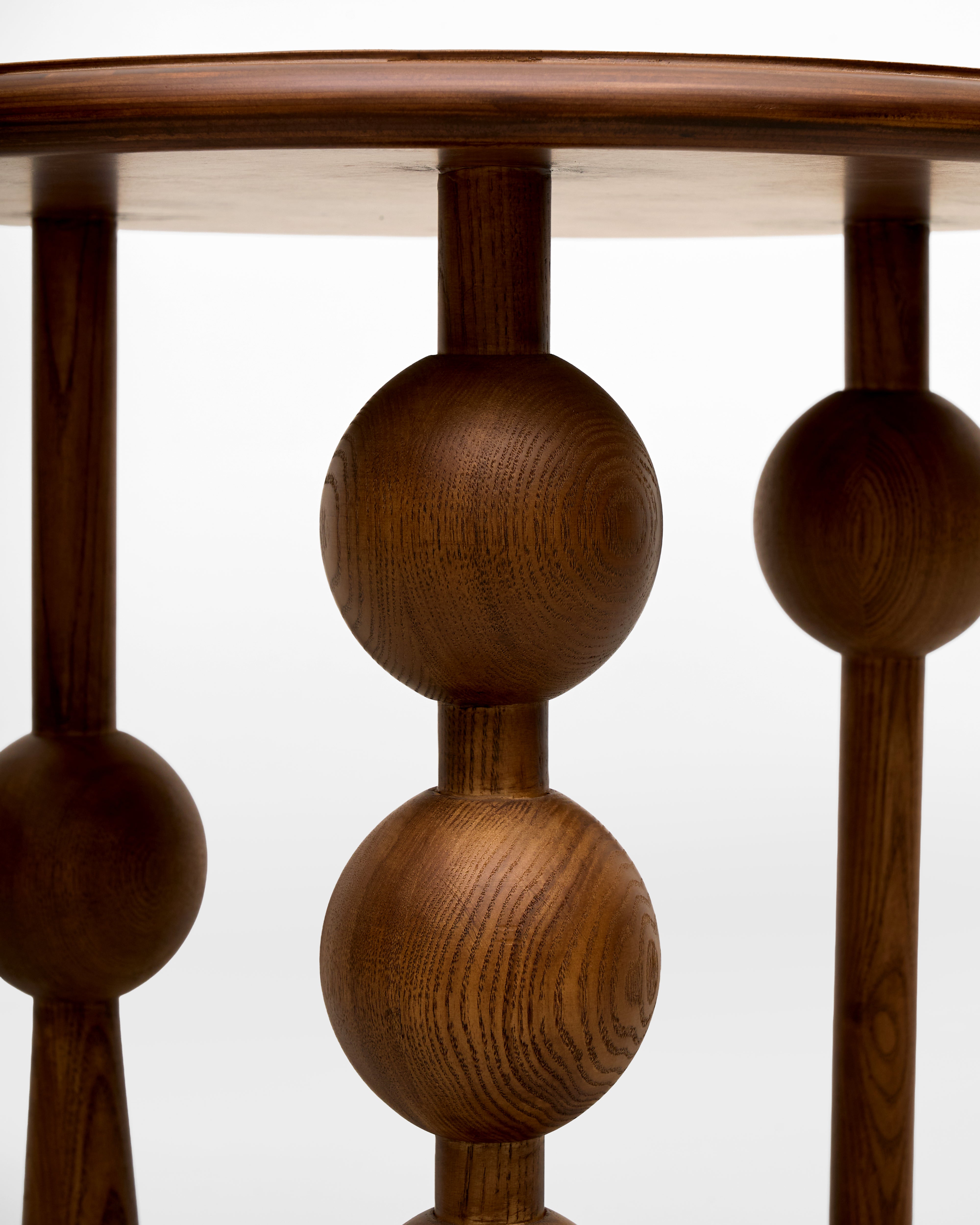 Wooden baluster with spherical design on side table wooden on a white background
