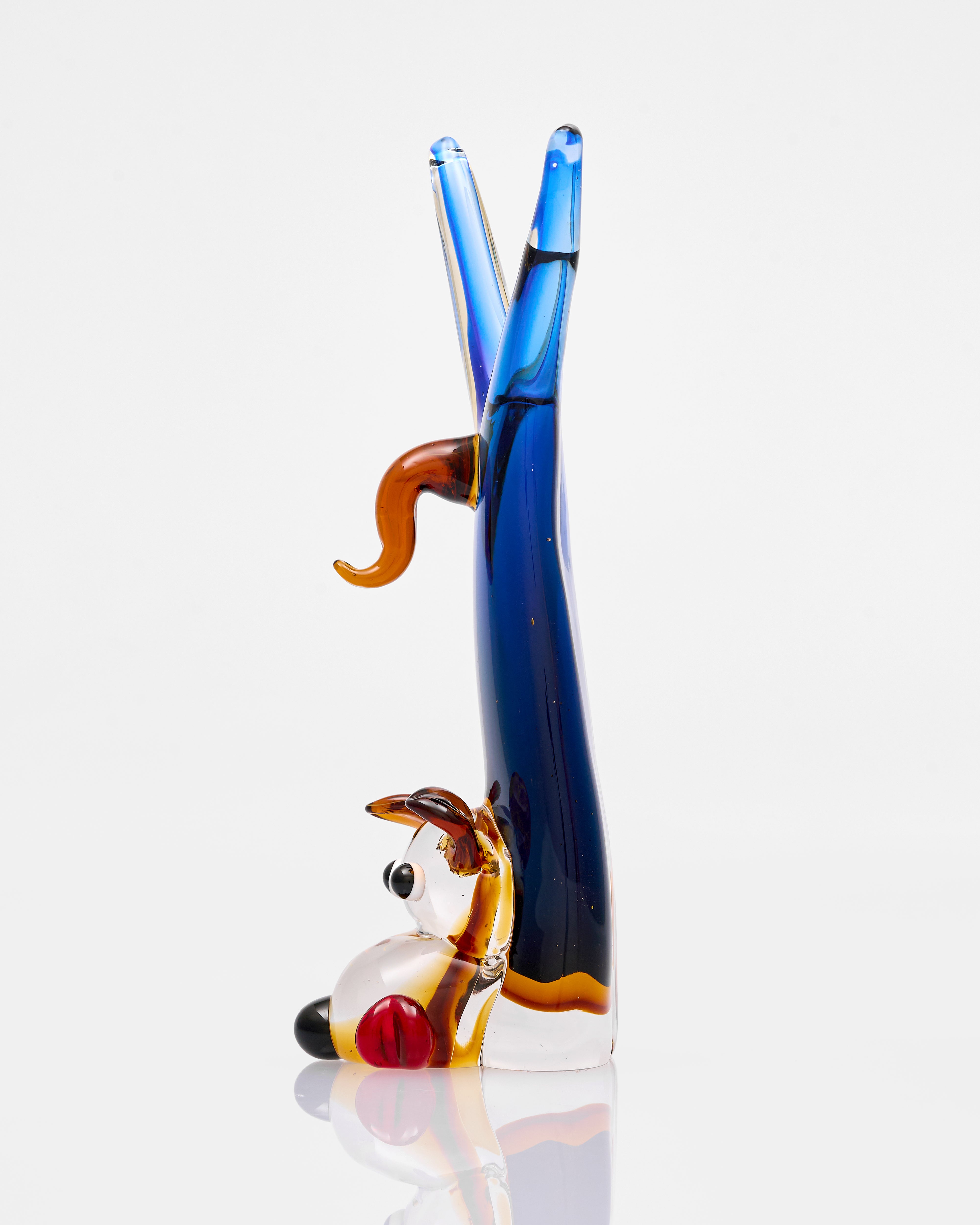 Glass sculpture of a dog and a bone on a white background