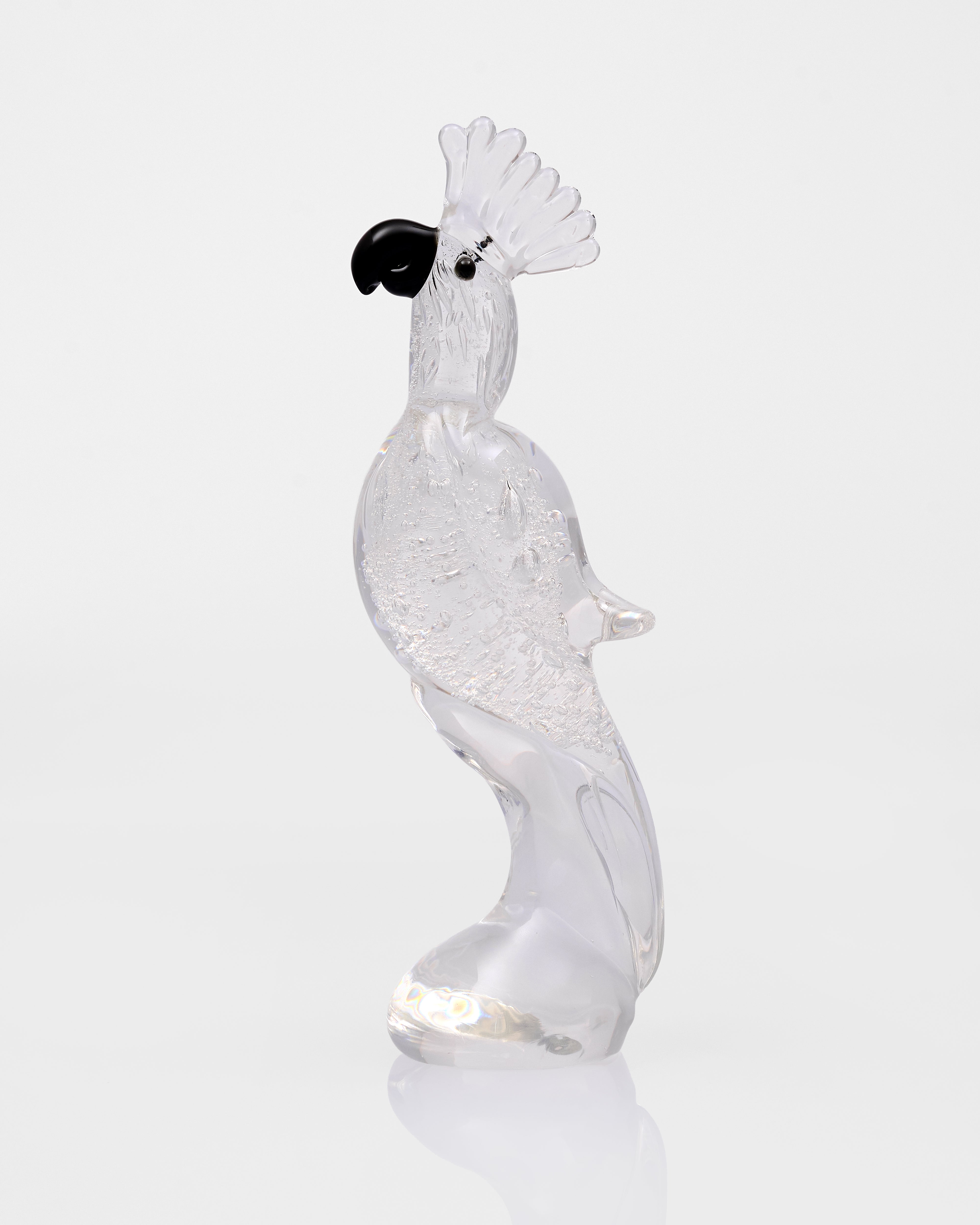 Clear glass sculpture of a rooster on a white background