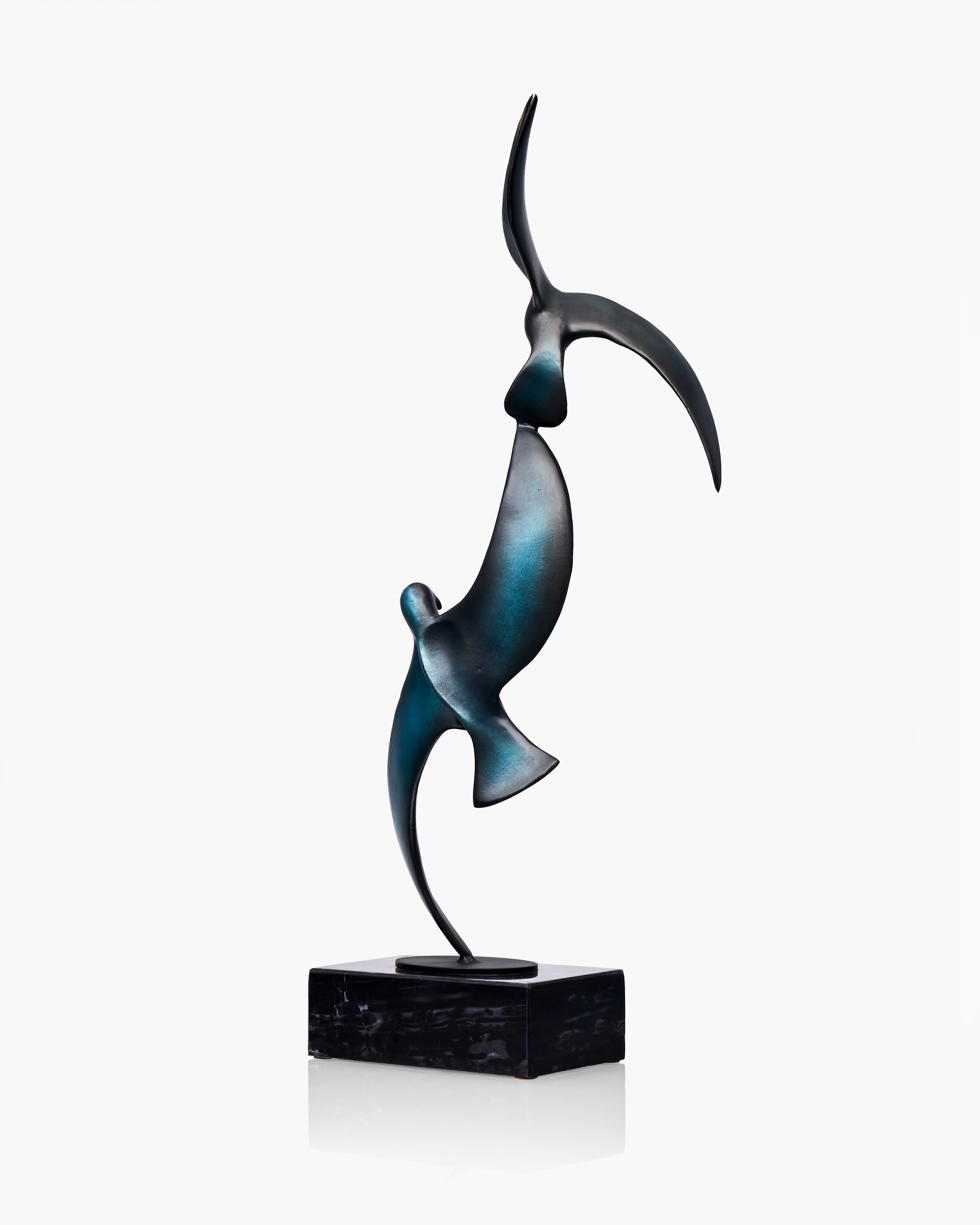 Abstract sculpture of two birds in a dynamic pose on a white background