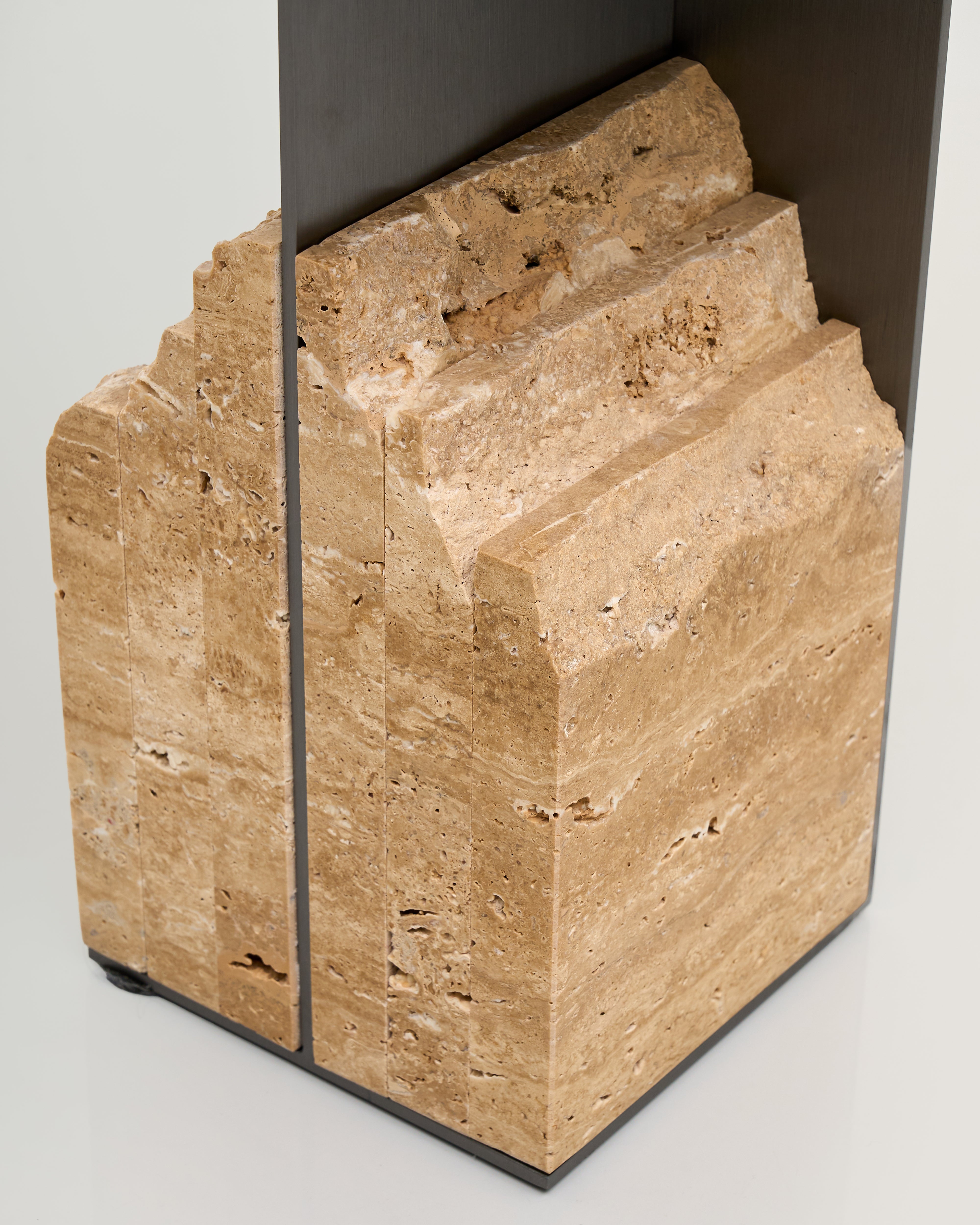 Beige marble blocks with a black base on a light gray background