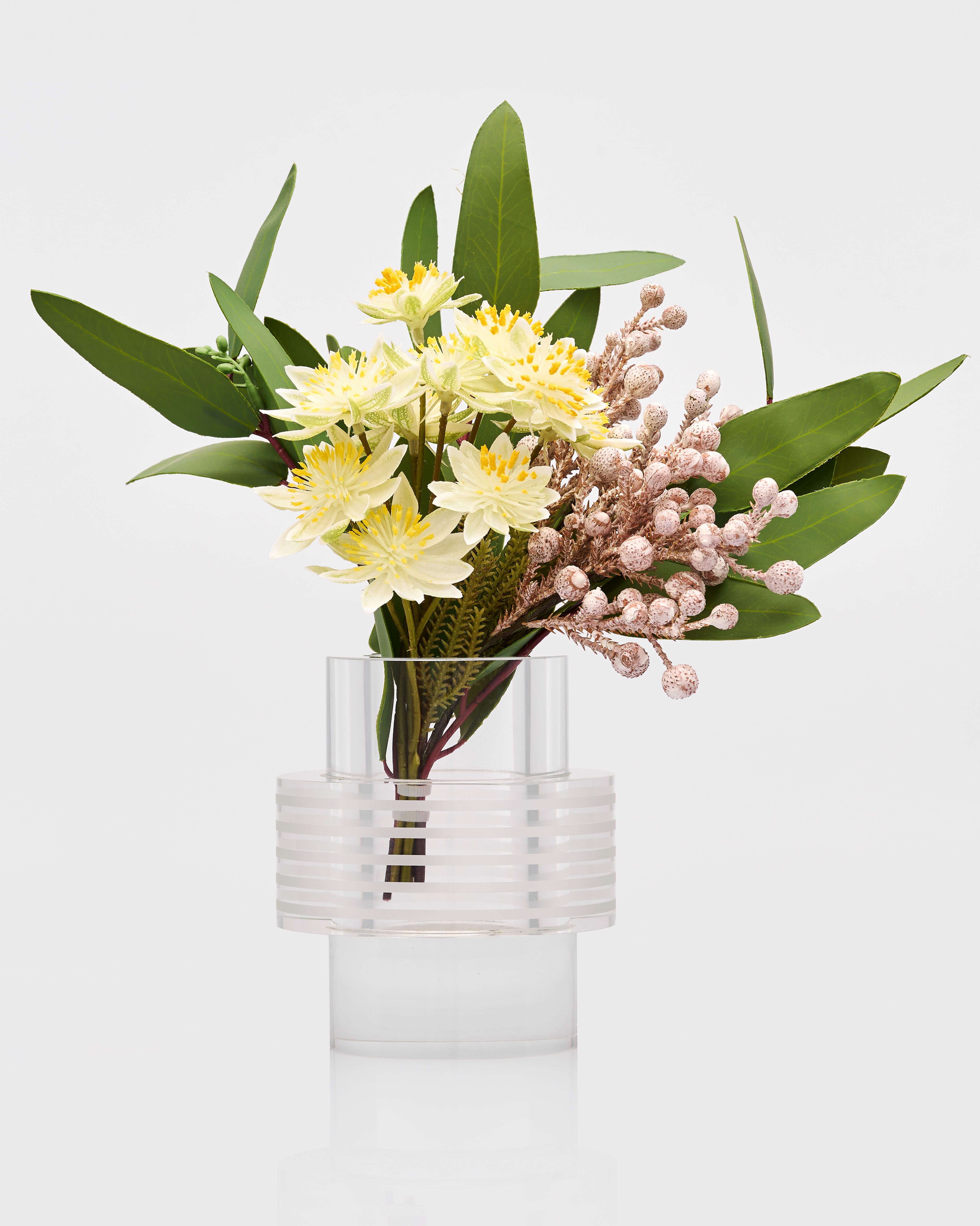 Clear glass vase with a bouquet of flowers on a white background