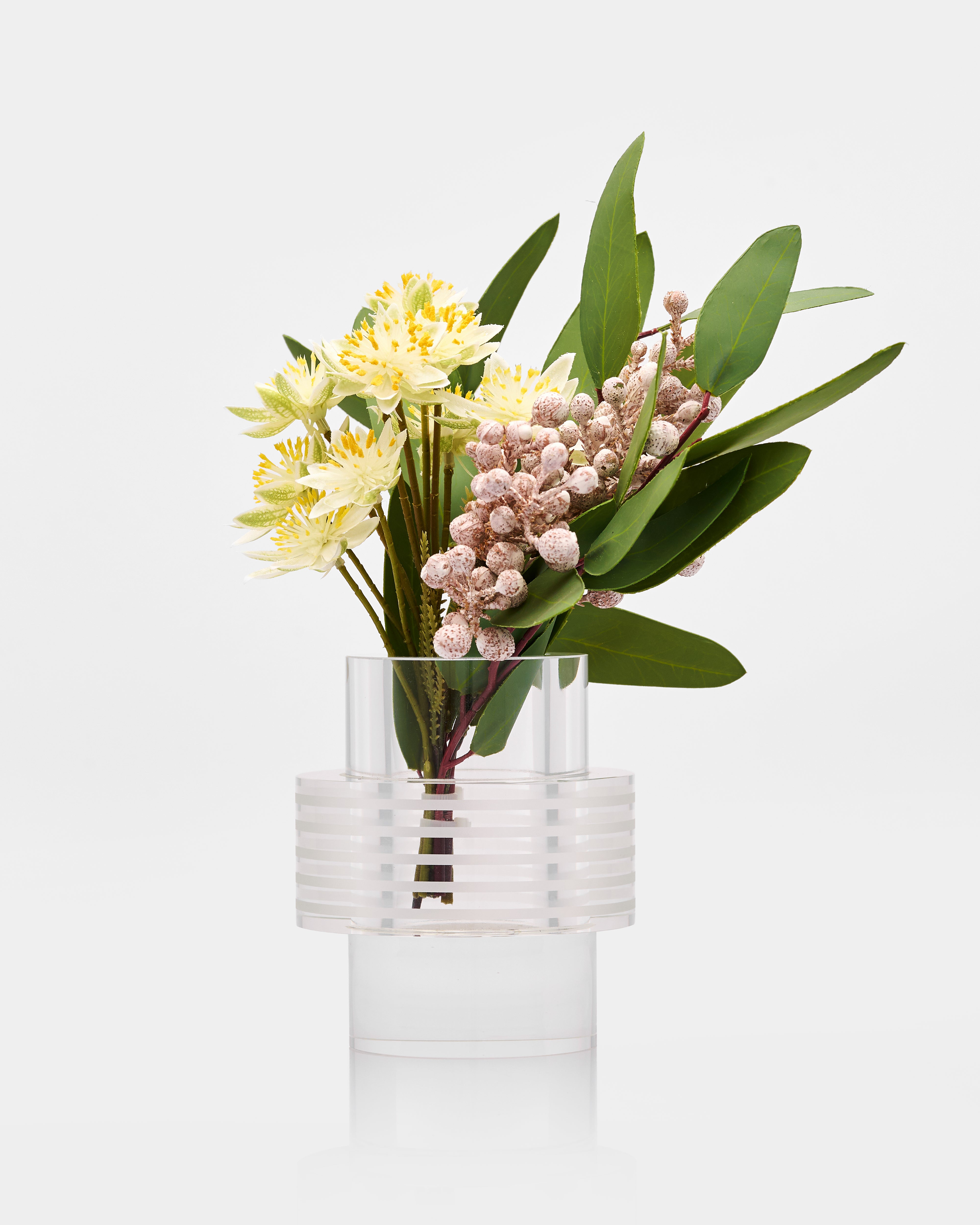 Clear glass vase with a bouquet of flowers on a white background