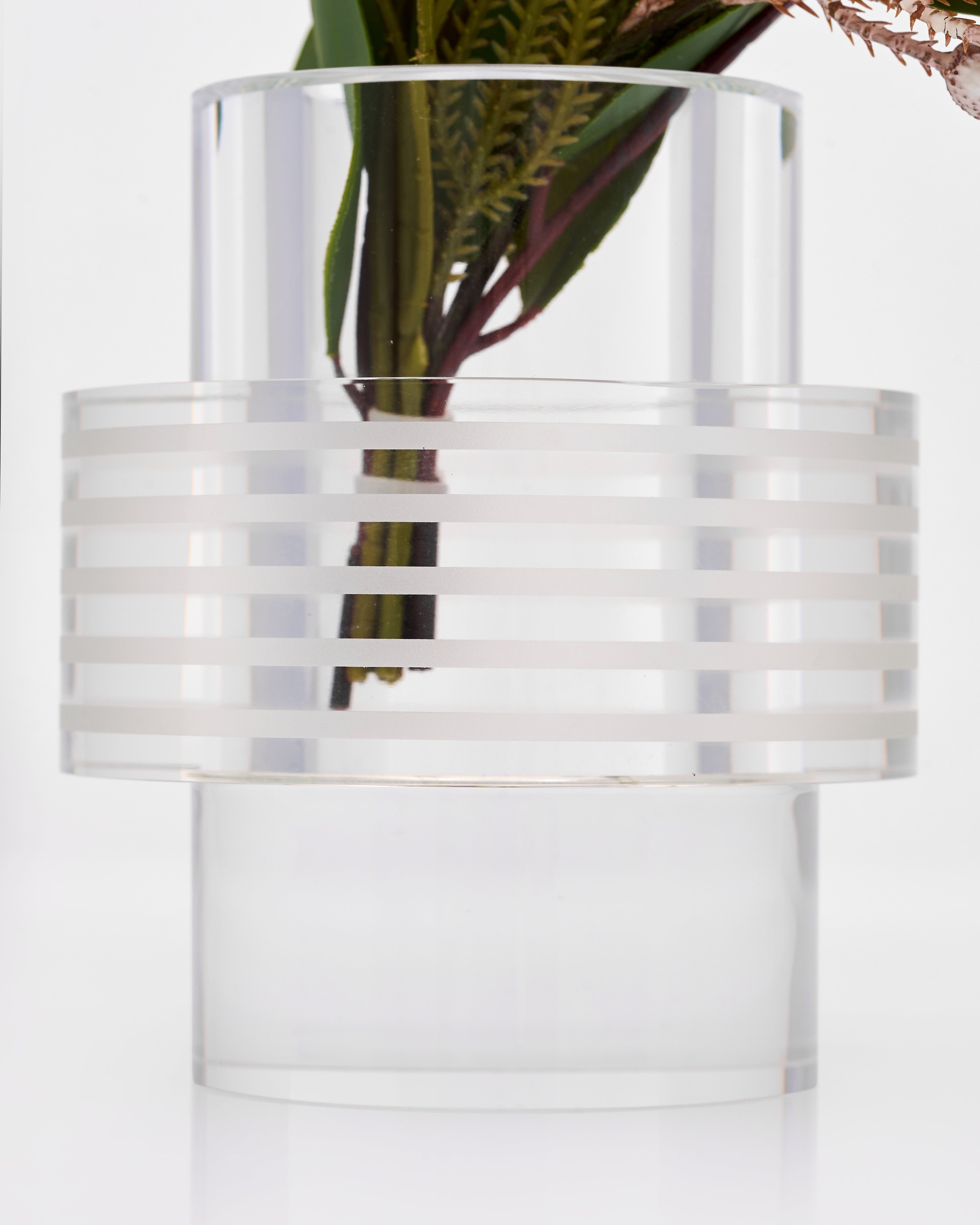 Clear glass vase with striped design on a white background