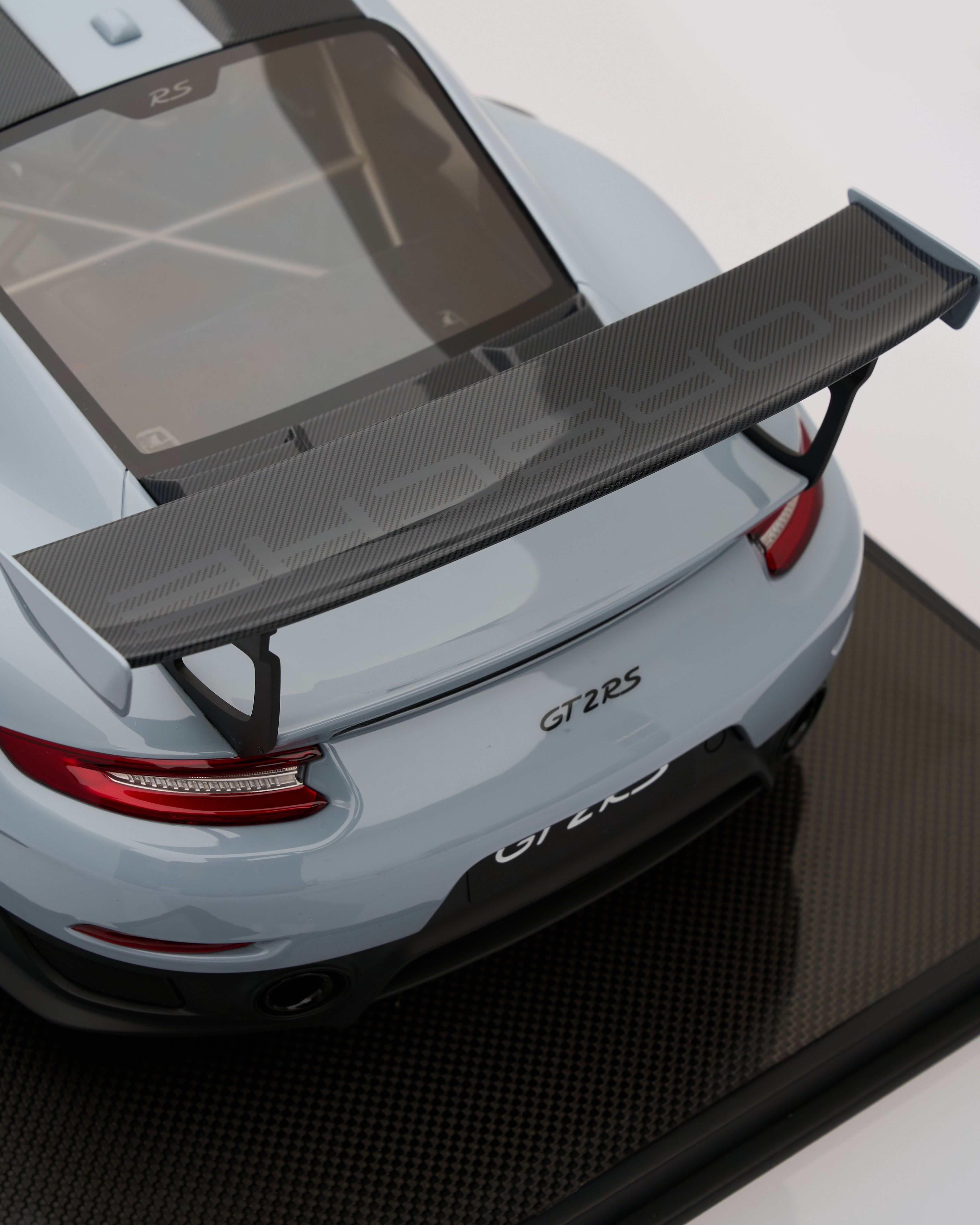Car with a carbon fiber wing on a white background