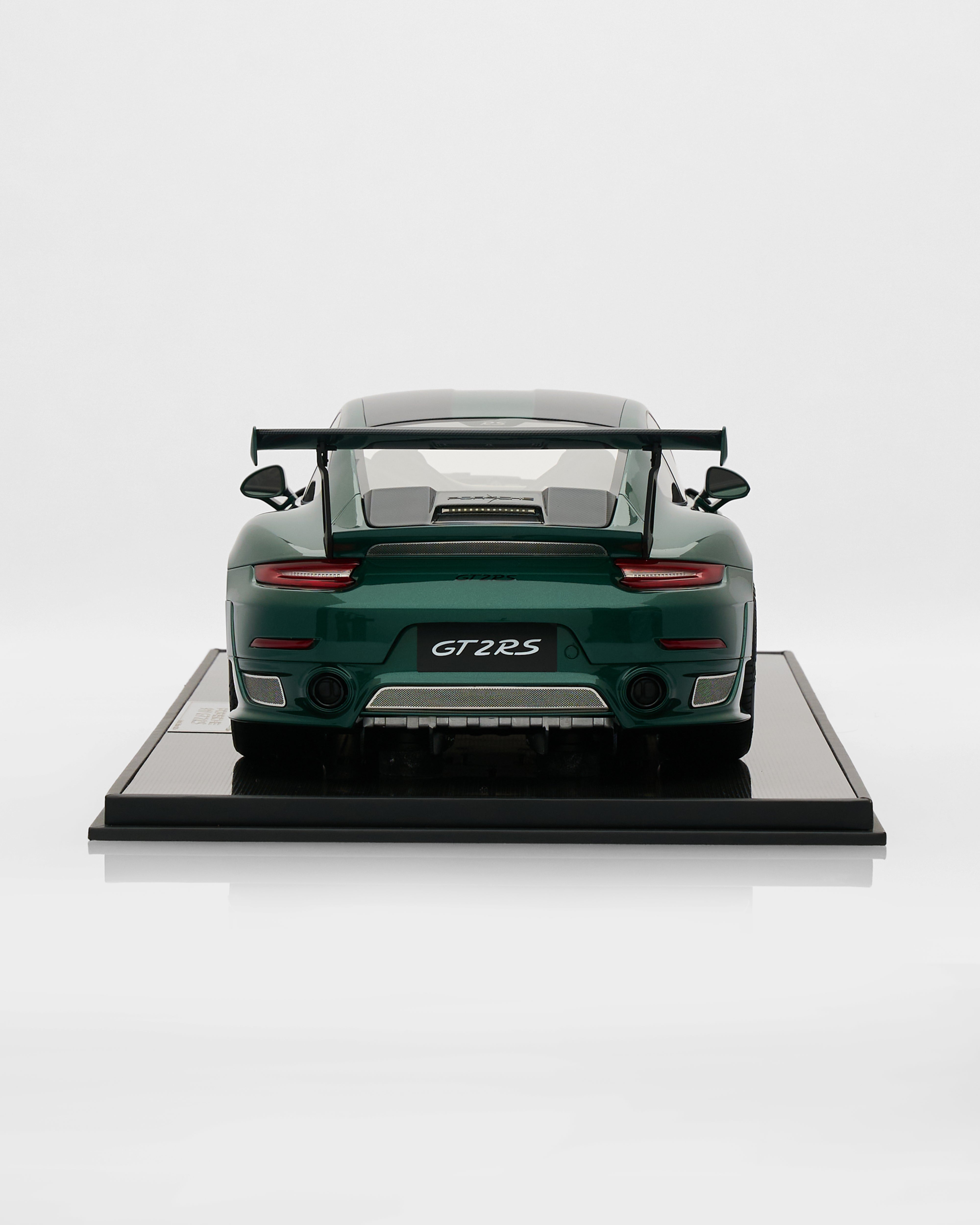 Model car on a display stand with 'GT2 RS' branding on a white background