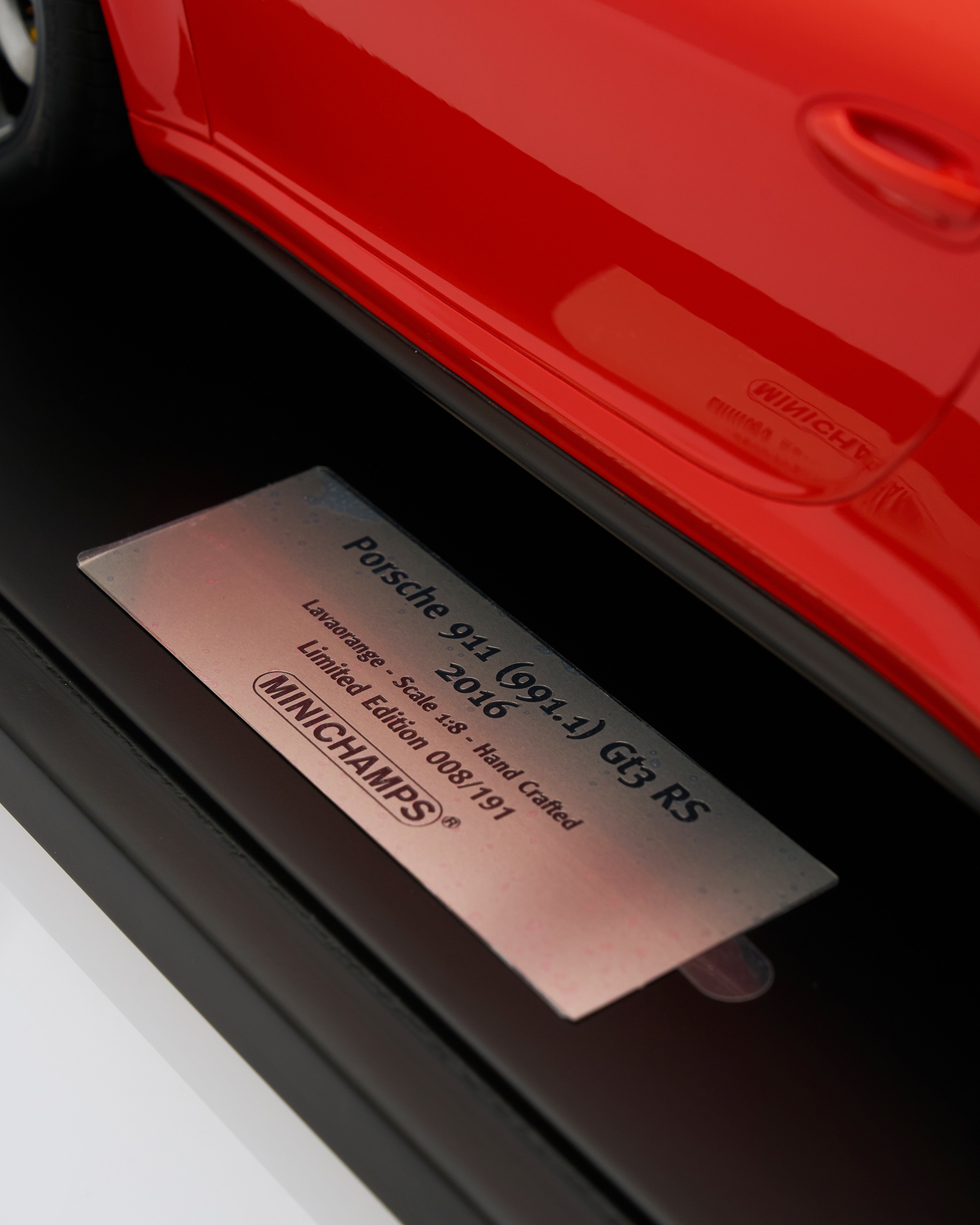Close-up of a Porsche model label on a car, with 'Minichamps' branding.