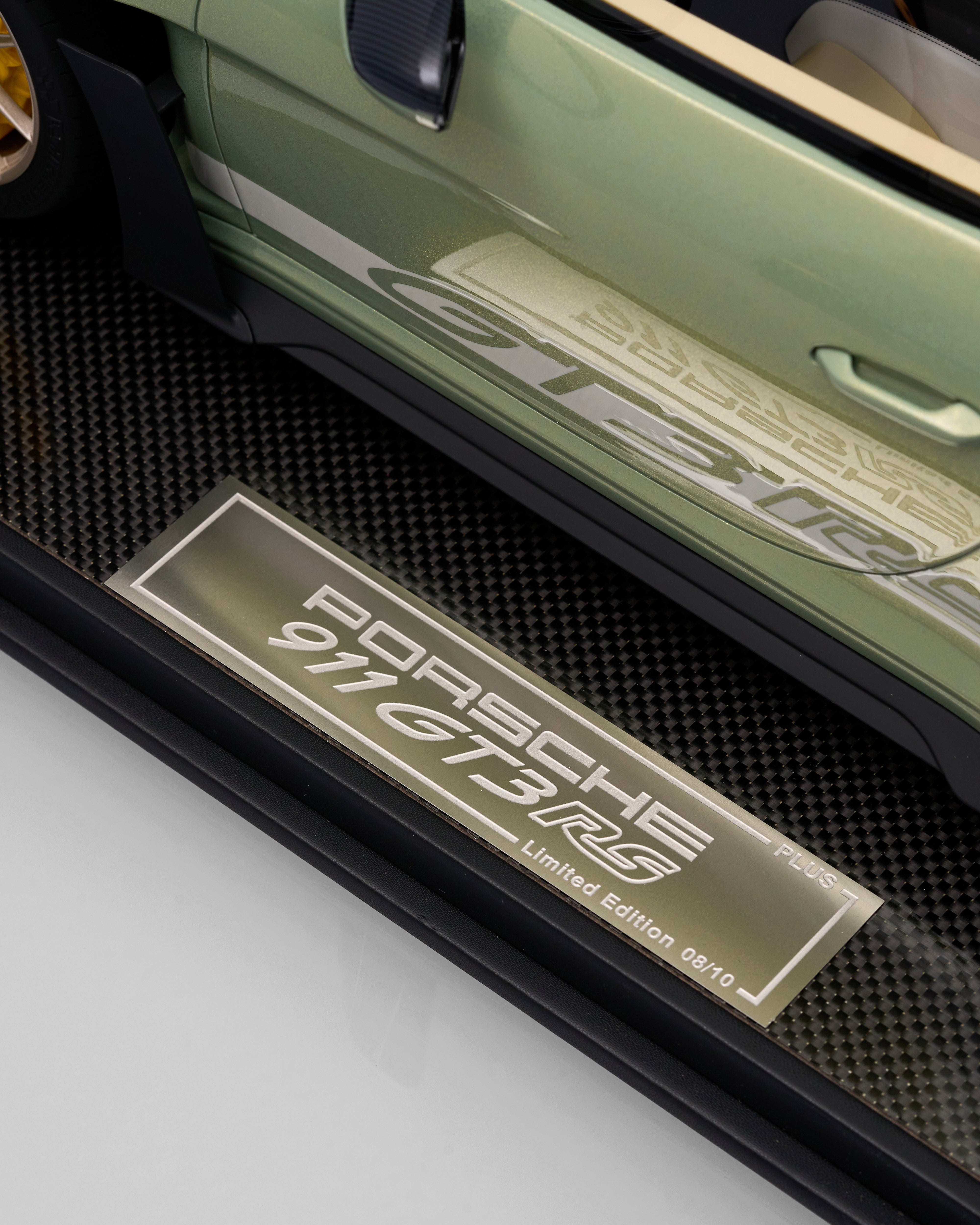 Close-up of a Porsche 911 GT3 RS door sill with carbon fiber finish