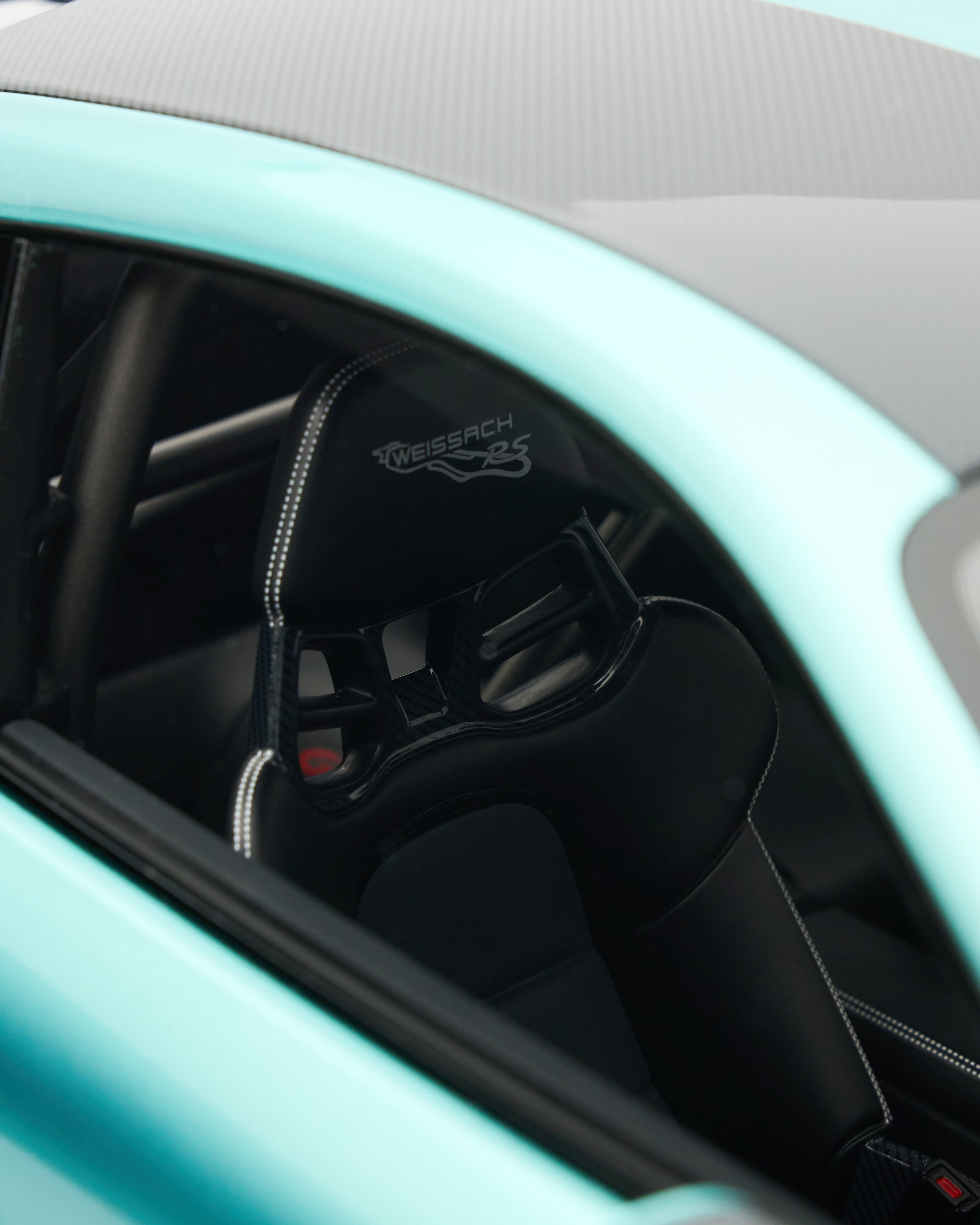 Close-up of a car seat with a visible brand logo inside a vehicle.