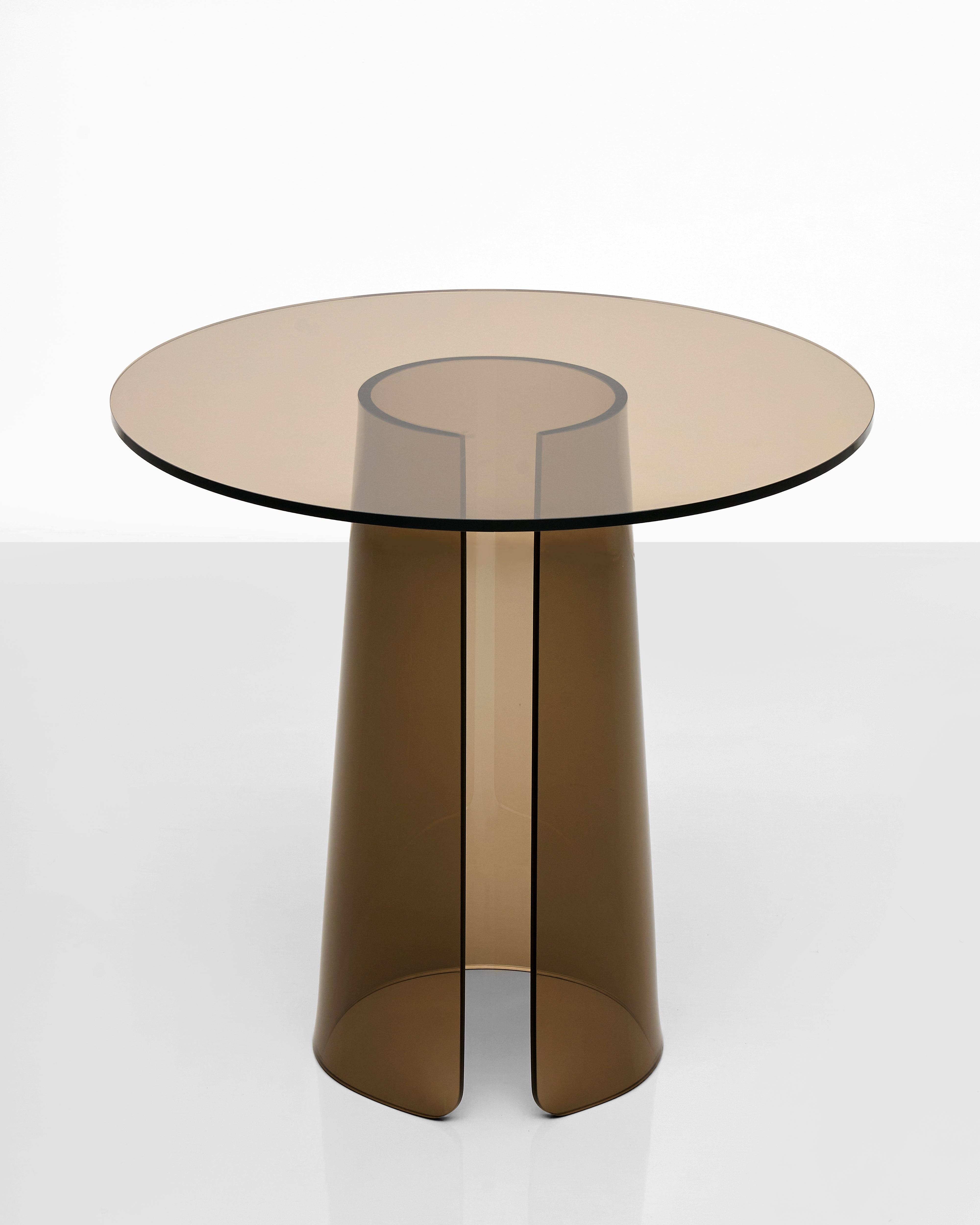Modern acrylic side table with transparent cylindrical legs on a white background