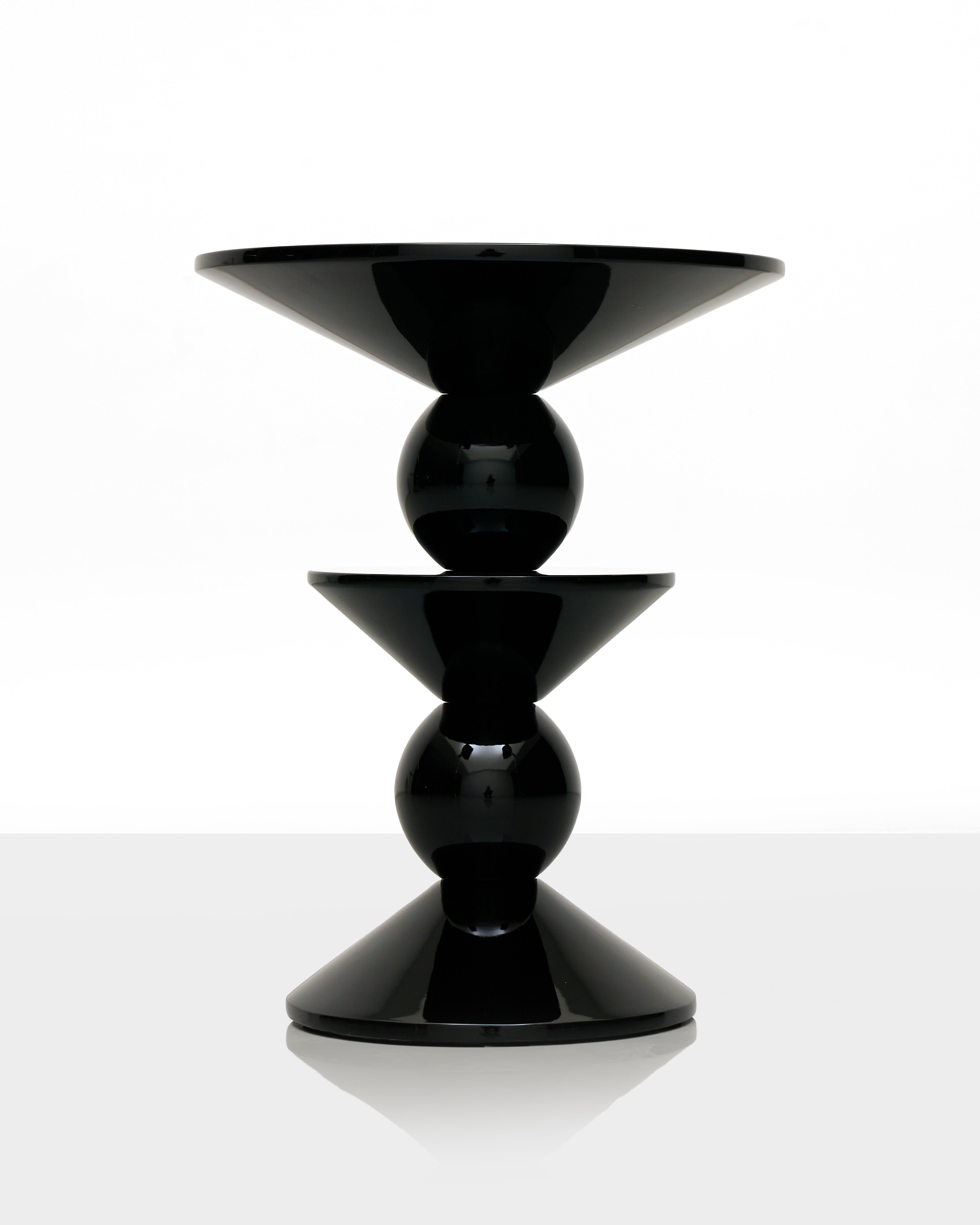 Black fiber glass table with a modern design on a white background