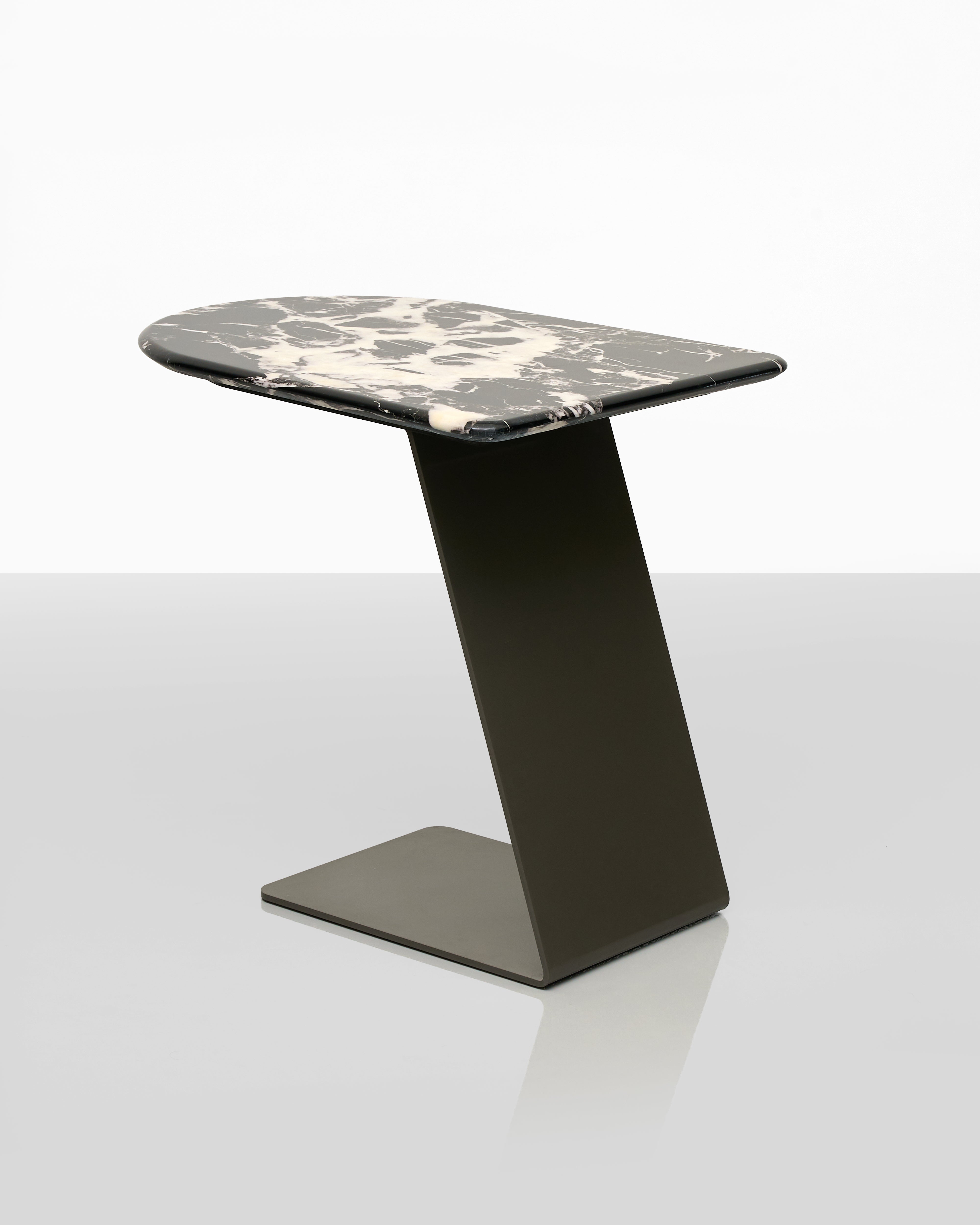 Modern side table with black base and marble-patterned top on a white background